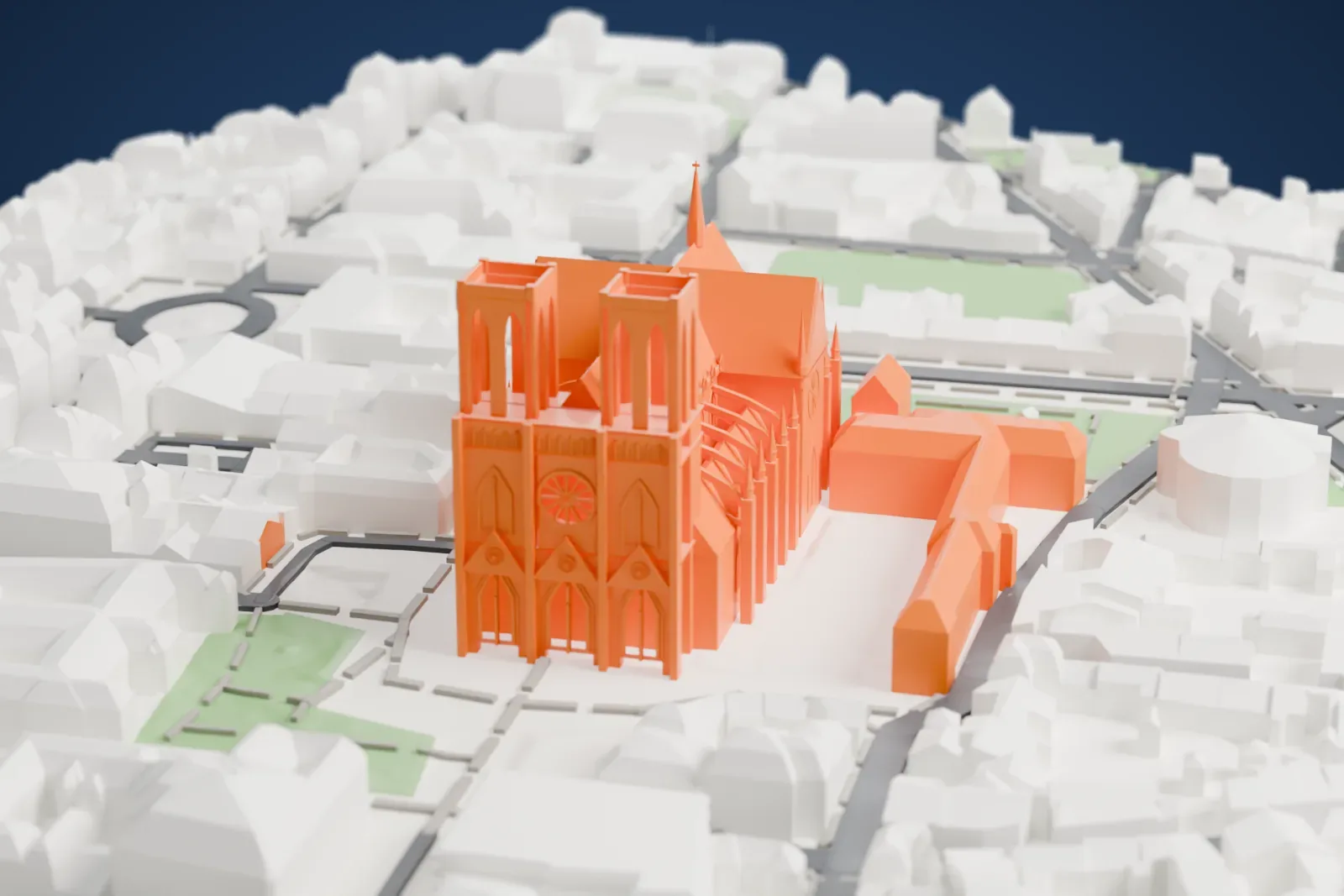 A white 3D print of Reims Cathedral, a long church with twin towers, flying buttresses and a slim spire, set among small buildings, streets and a few gardens.
