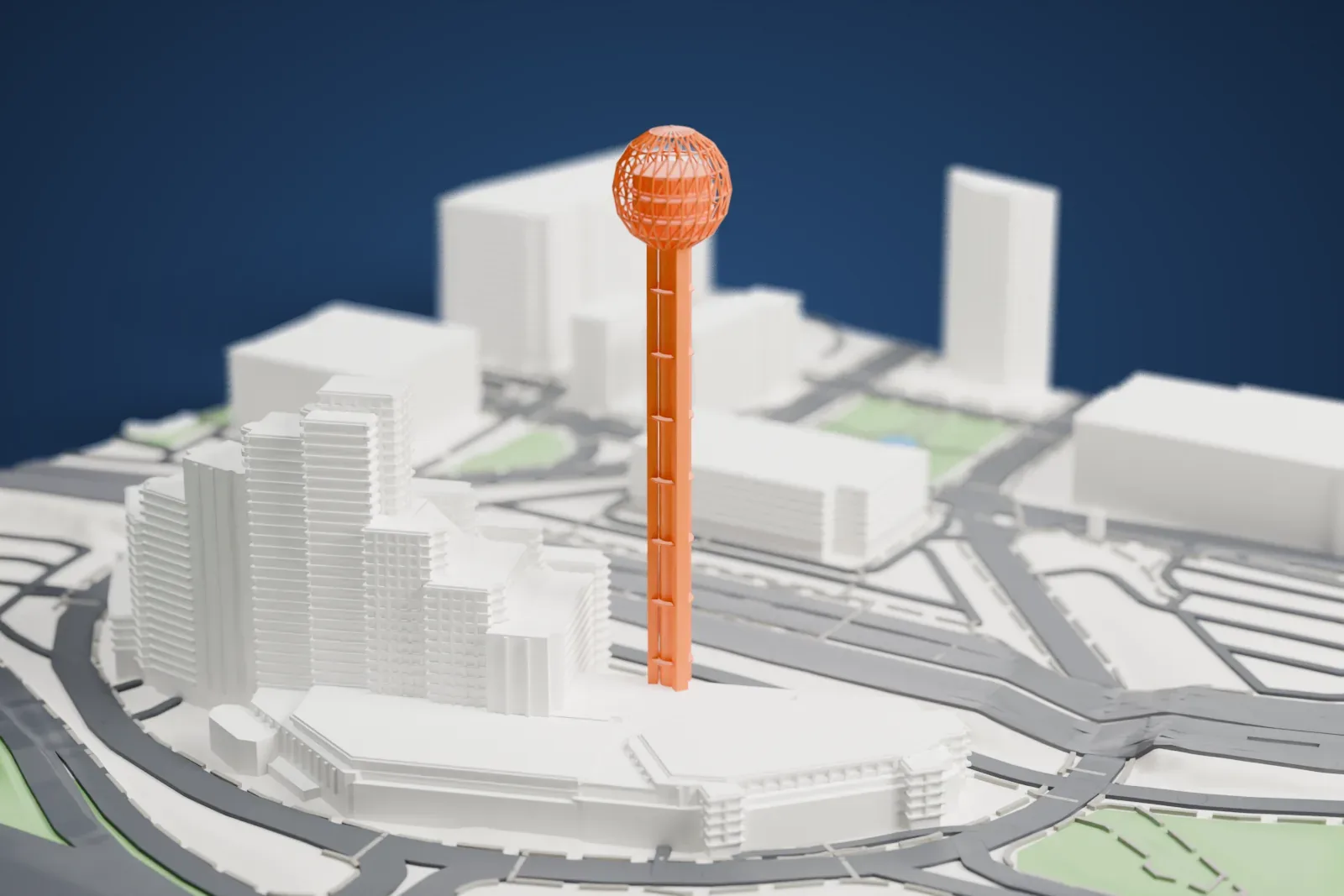 A white 3D print of Reunion Tower, a tall slender shaft topped by an open lattice sphere, standing among buildings, wide roads and patches of park.