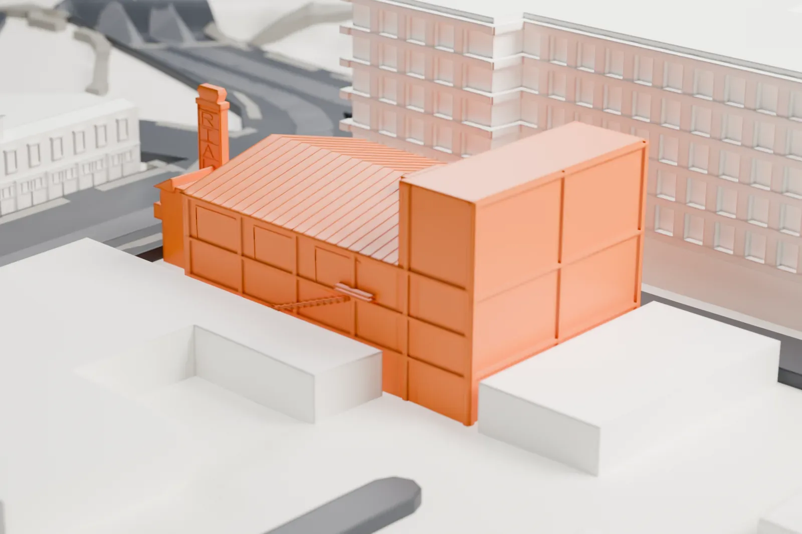 A white 3D print of the Rialto Theatre, a narrow building with a long ridged roof and a slim chimney at the front, squeezed between neighboring buildings and streets.