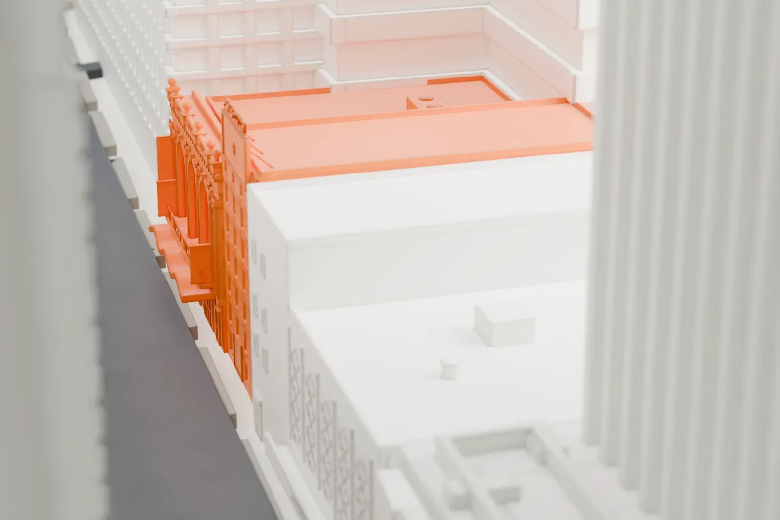 A white 3D print of the Richard Rodgers Theatre, a small low building almost entirely hidden between much taller Midtown towers.