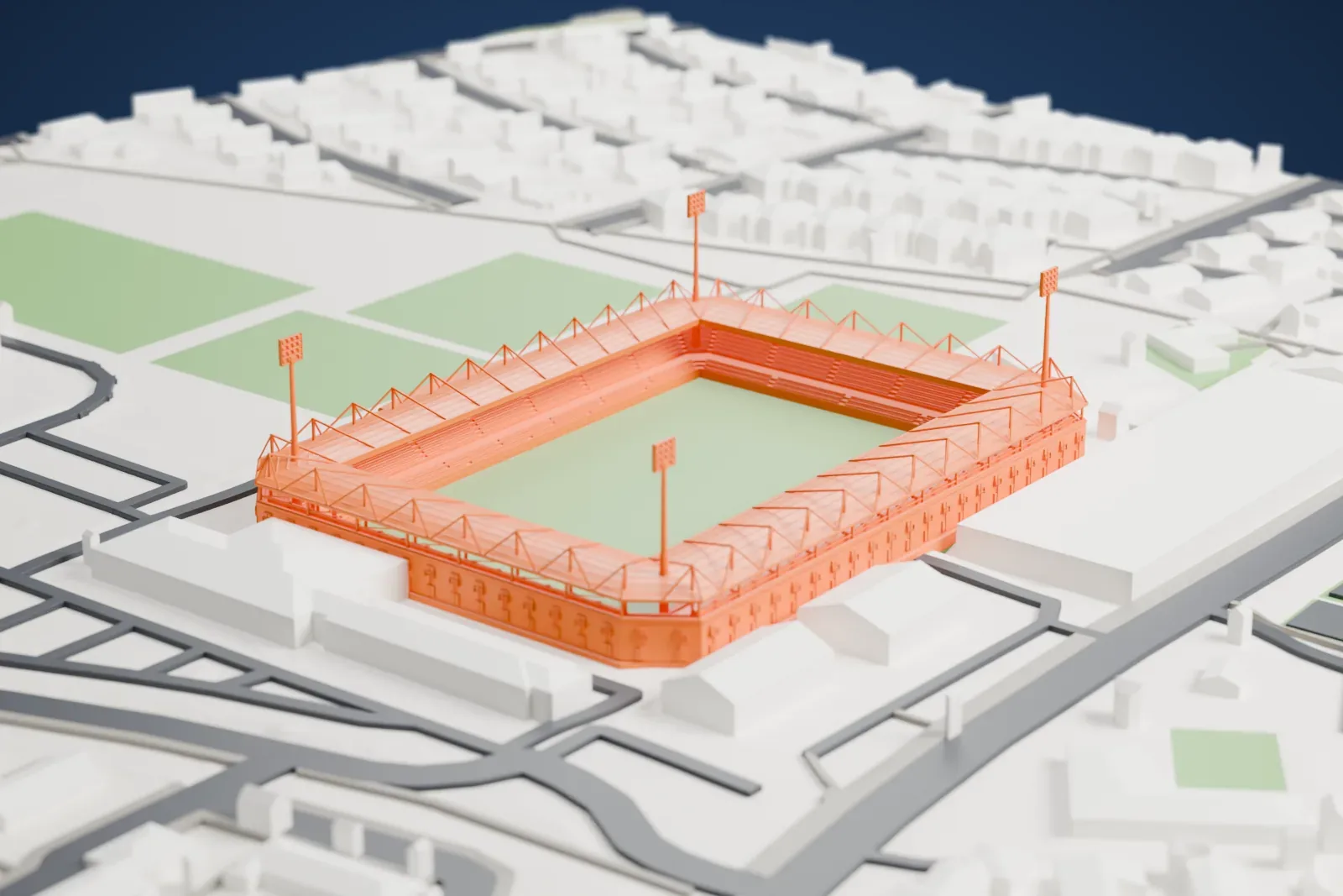 A white 3D print of Right to Dream Park, a low rectangular stadium with four covered stands and floodlight masts, surrounded by streets and buildings.