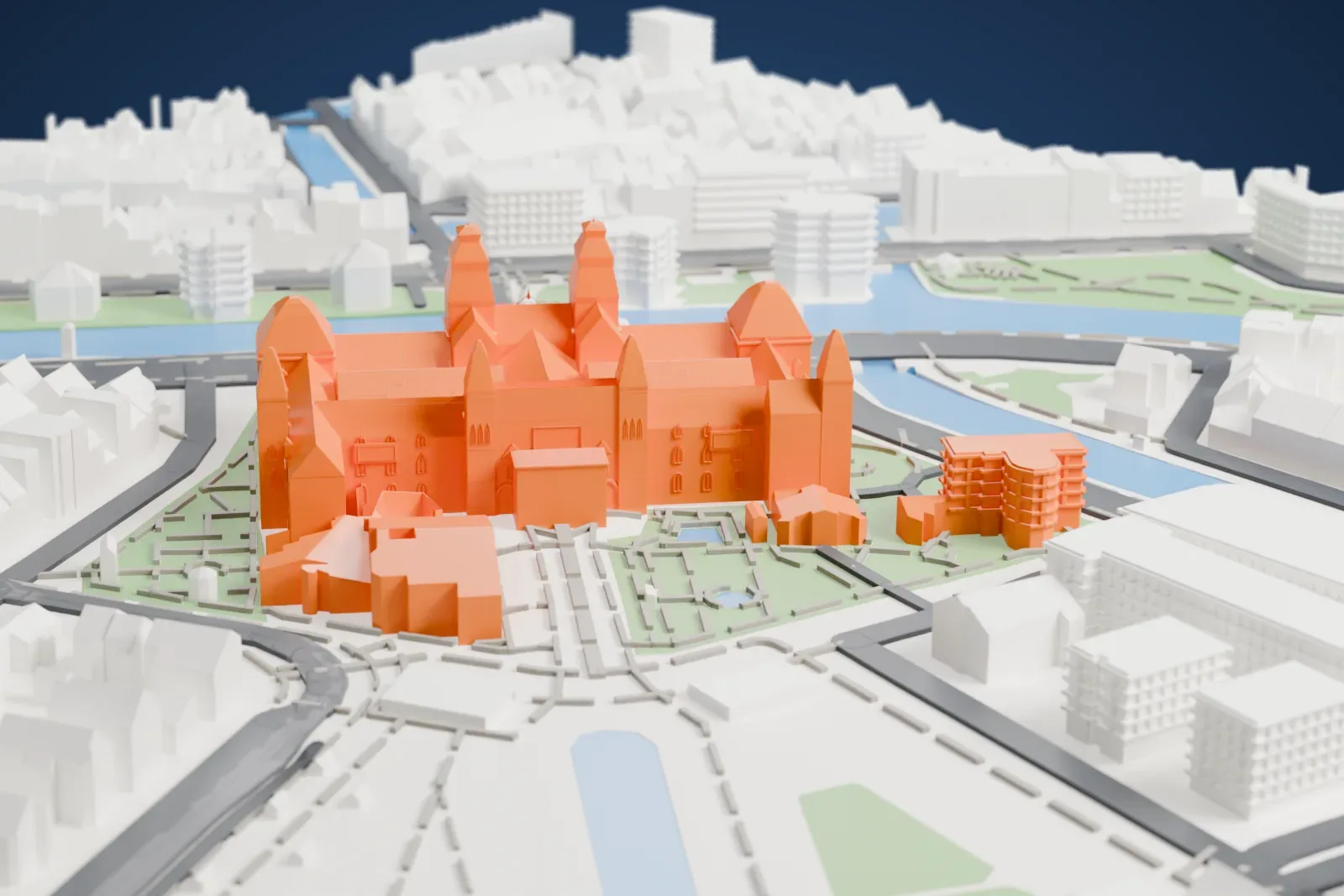 A white 3D print of the Rijksmuseum, a large building with steep-roofed towers and pitched roofs, standing among gardens, canals and streets.
