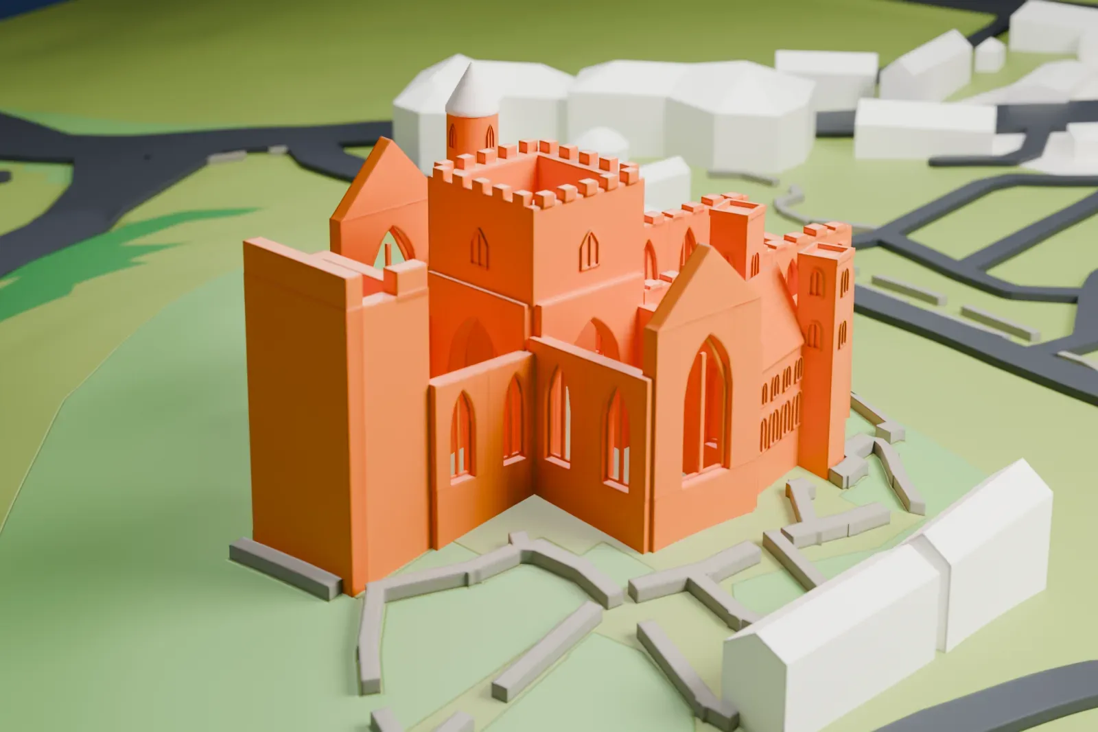 A white 3D print of the Rock of Cashel, a cluster of roofless stone walls, a conical-topped round tower and a battlemented central tower, set in green fields inside a low wall.