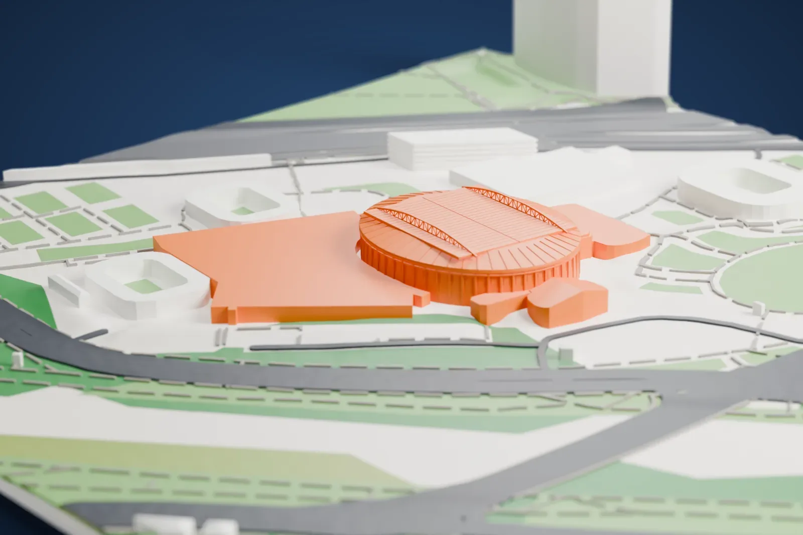 A white 3D print of Rod Laver Arena, a round arena with a ribbed wall and a roof of flat panels on two arched trusses, set among neighboring buildings, paths and lawns, with water nearby.