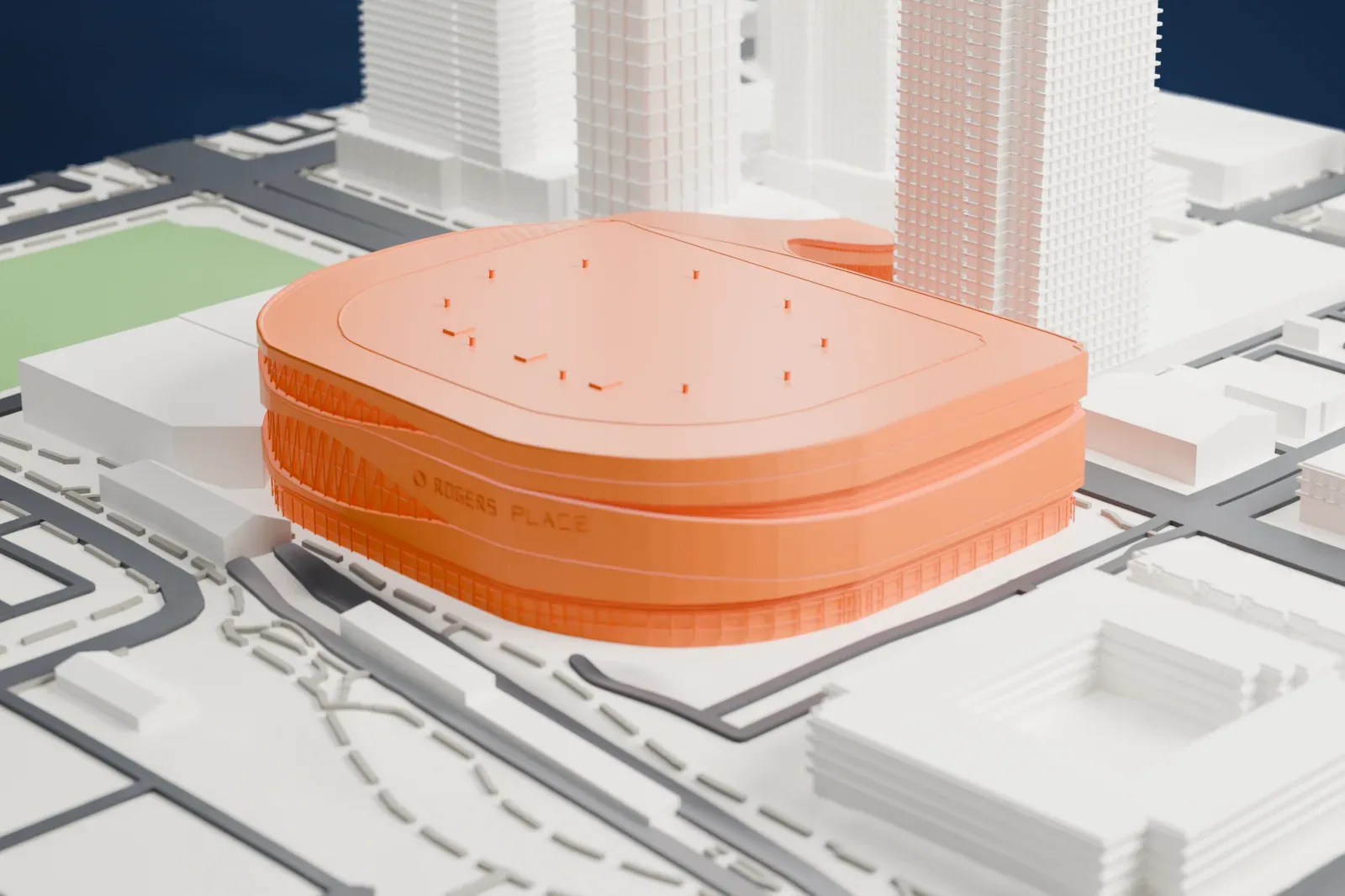 A white 3D print of Rogers Place, a rounded arena with a flat roof and a curved wing, surrounded by downtown towers, streets and a patch of grass.