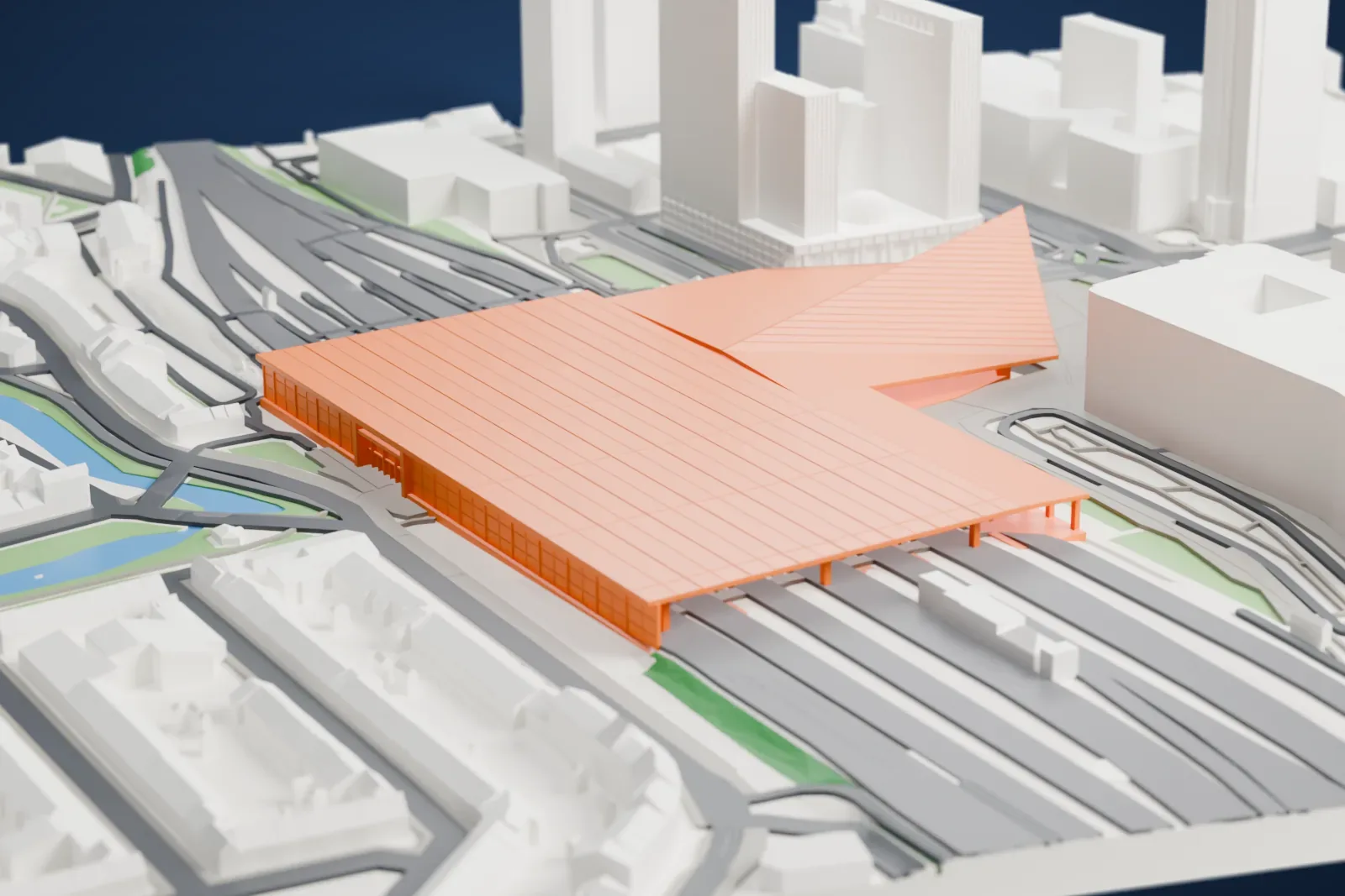 A white 3D print of Rotterdam Centraal station, a station building set among surrounding city buildings and streets.