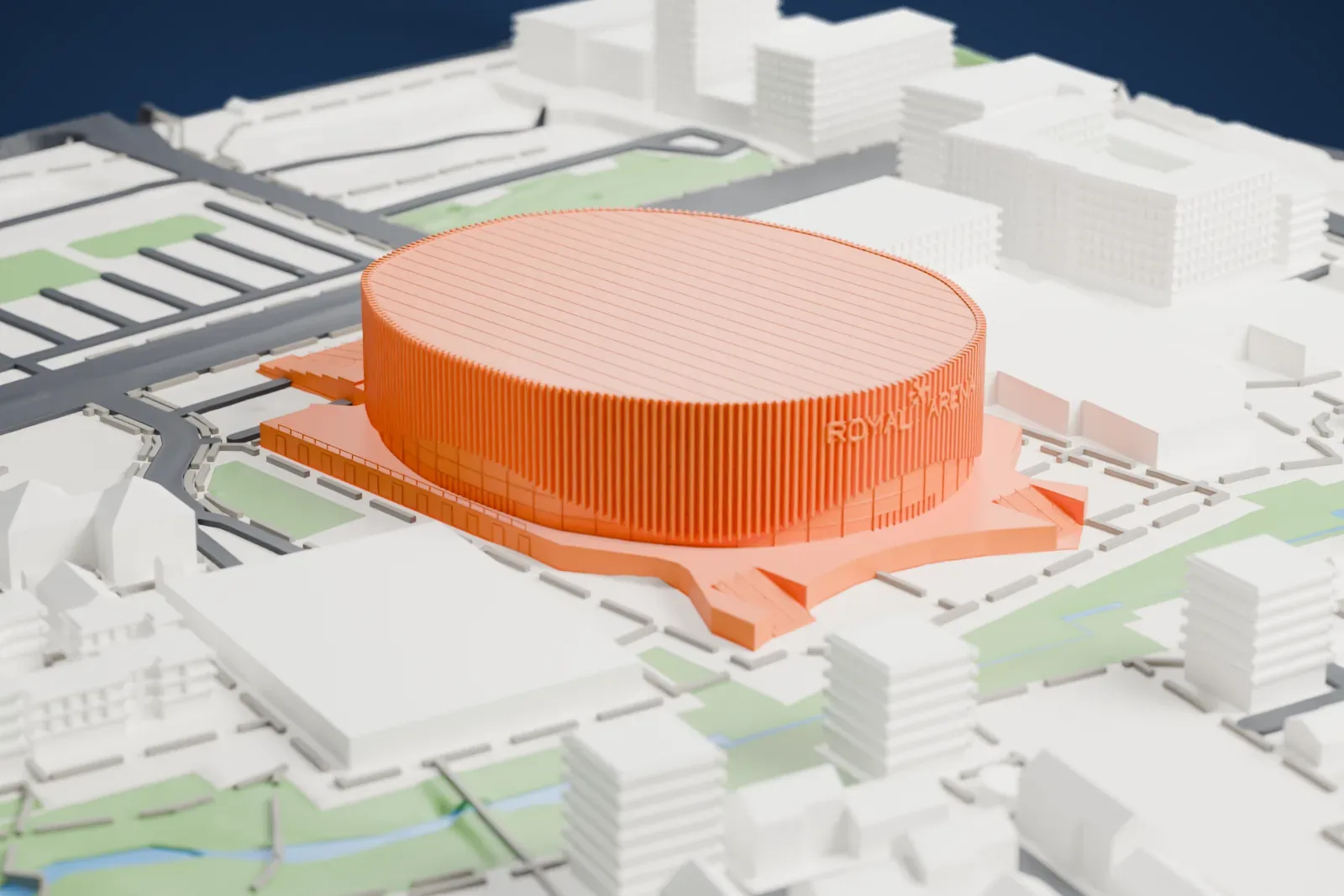 A white 3D print of the Royal Arena, a wide round arena with a ribbed wall and a flat roof, surrounded by roads, green strips, a small waterway and low buildings.