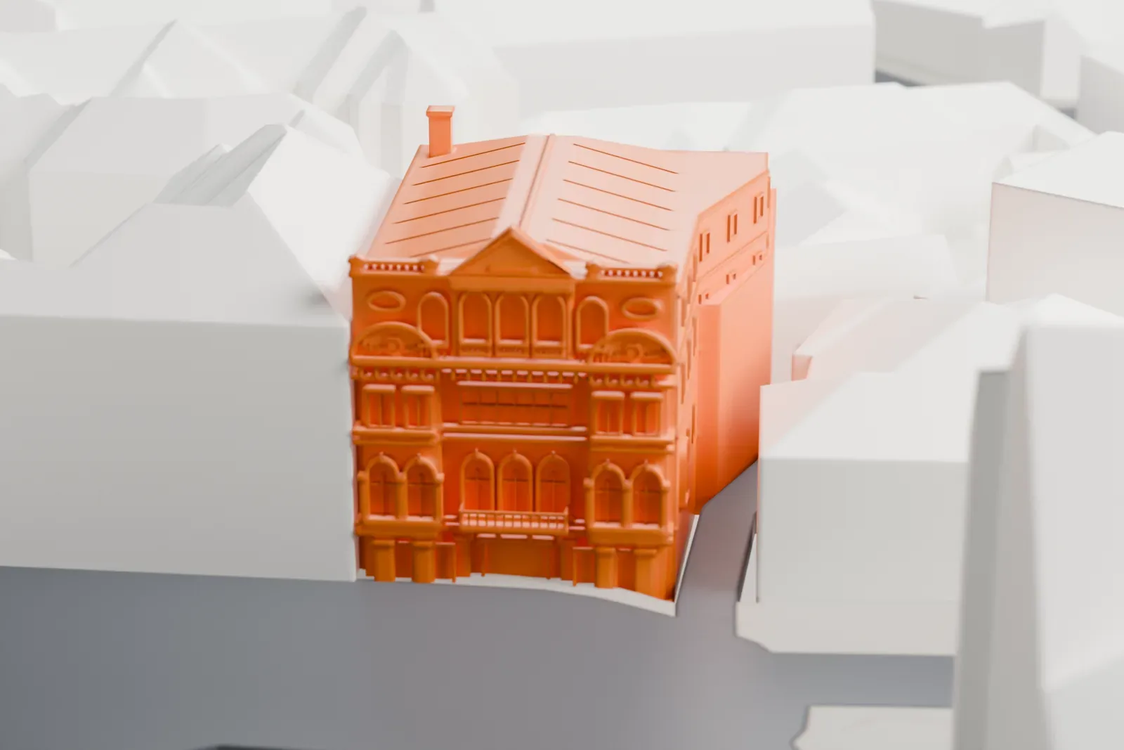 A white 3D print of the Royal Court Theatre on Sloane Square, among the surrounding streets and buildings of London.