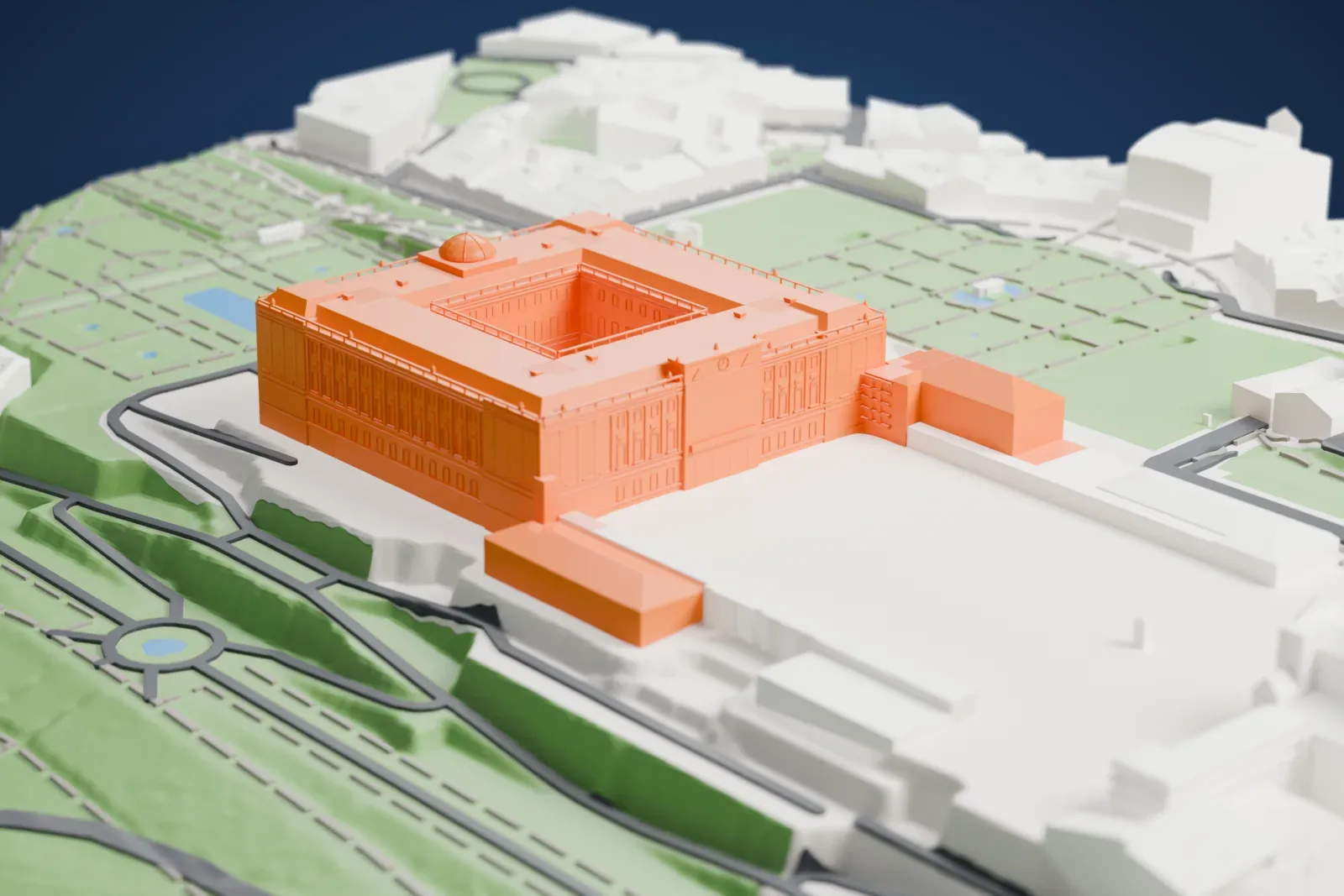 A white 3D print of the Royal Palace of Madrid, a large rectangular palace with a central courtyard and a small dome, surrounded by gardens, open plazas and roads.