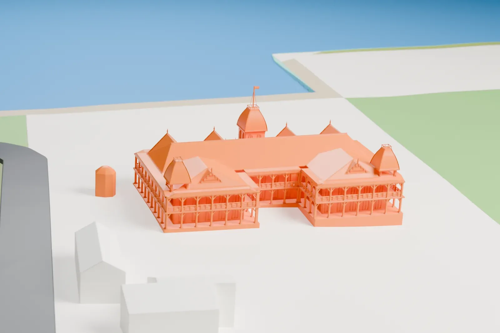 A white 3D print of the Royal Palace in Nukuʻalofa, a long two-story building with verandas, steep gabled roofs and small domed turrets, standing on open grounds near a road and the waterfront.