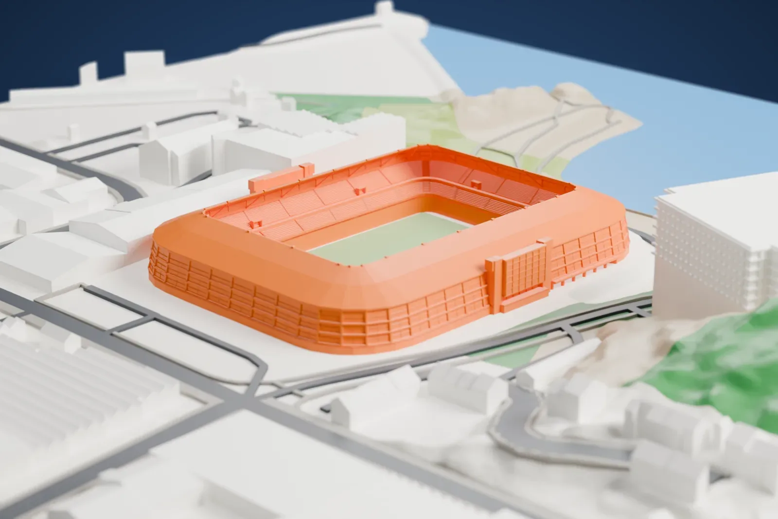 A white 3D print of Sør Arena, a rounded stadium with an open center and a broad roof ring, set among surrounding streets and buildings.