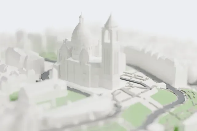 A white 3D print of the Sacré-Cœur Basilica model in Paris, with the streets around it.