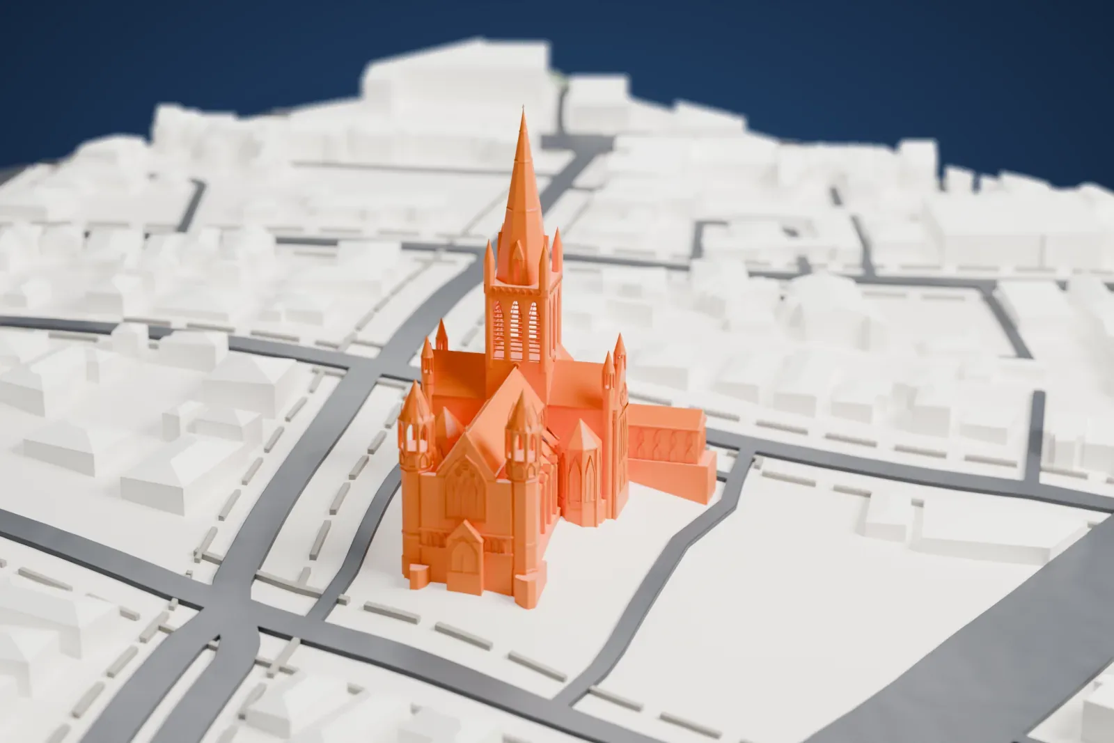 A white 3D print of Sacred Heart Cathedral in Bendigo, a church with a tall central spire and smaller towers, among streets and low buildings.