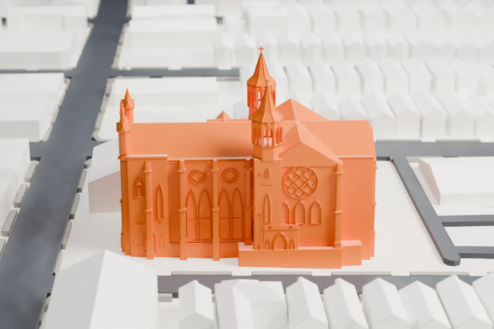 A white 3D print of Sacred Heart Church, a long church with a rose window, pointed turrets and a lower attached building, among gabled houses and streets.