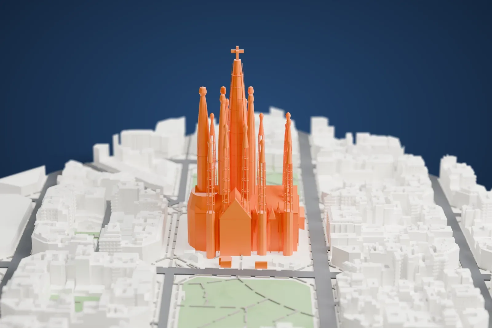 A white 3D print of Sagrada Família, a cluster of tall spires with a cross on the tallest, standing among city blocks, streets and small parks with ponds.