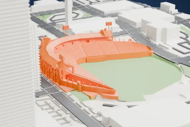 A white 3D print of Sahlen Field, a horseshoe-shaped ballpark with arched outer walls and light towers around a green field, among the streets and buildings of downtown Buffalo.