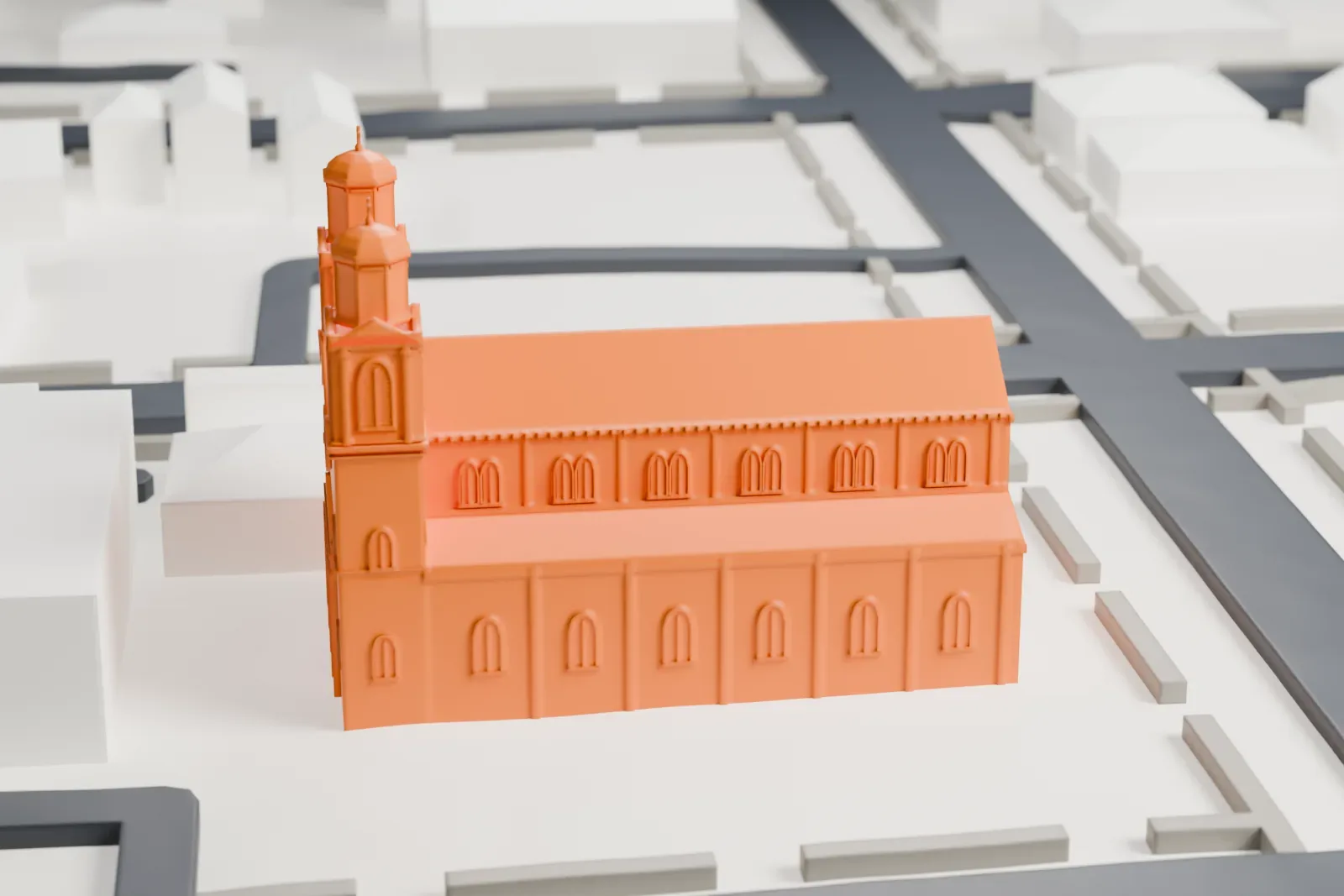 A white 3D print of Saint Mary of Mount Virgin Church, a long church with twin domed bell towers at the front, set among streets and a few neighboring buildings.
