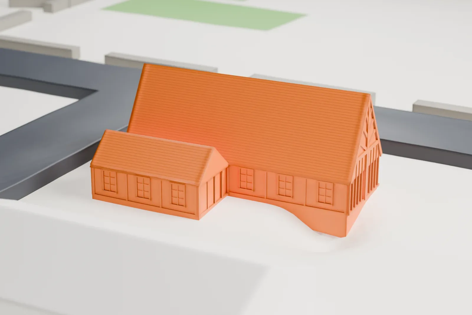 A white 3D print of Saint Mary's Chapel, a small steep-roofed church with a little belfry, on an open lot with streets and a few larger buildings nearby.