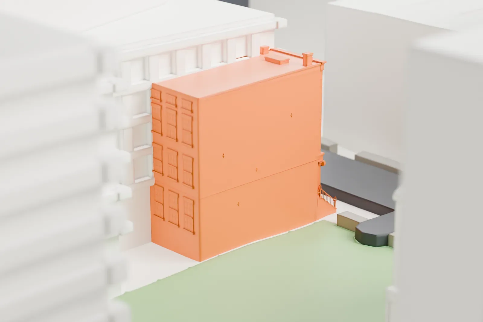 A white 3D print of the Samuel Tredwell Skidmore House, a small building set within a dense grid of taller buildings and streets.