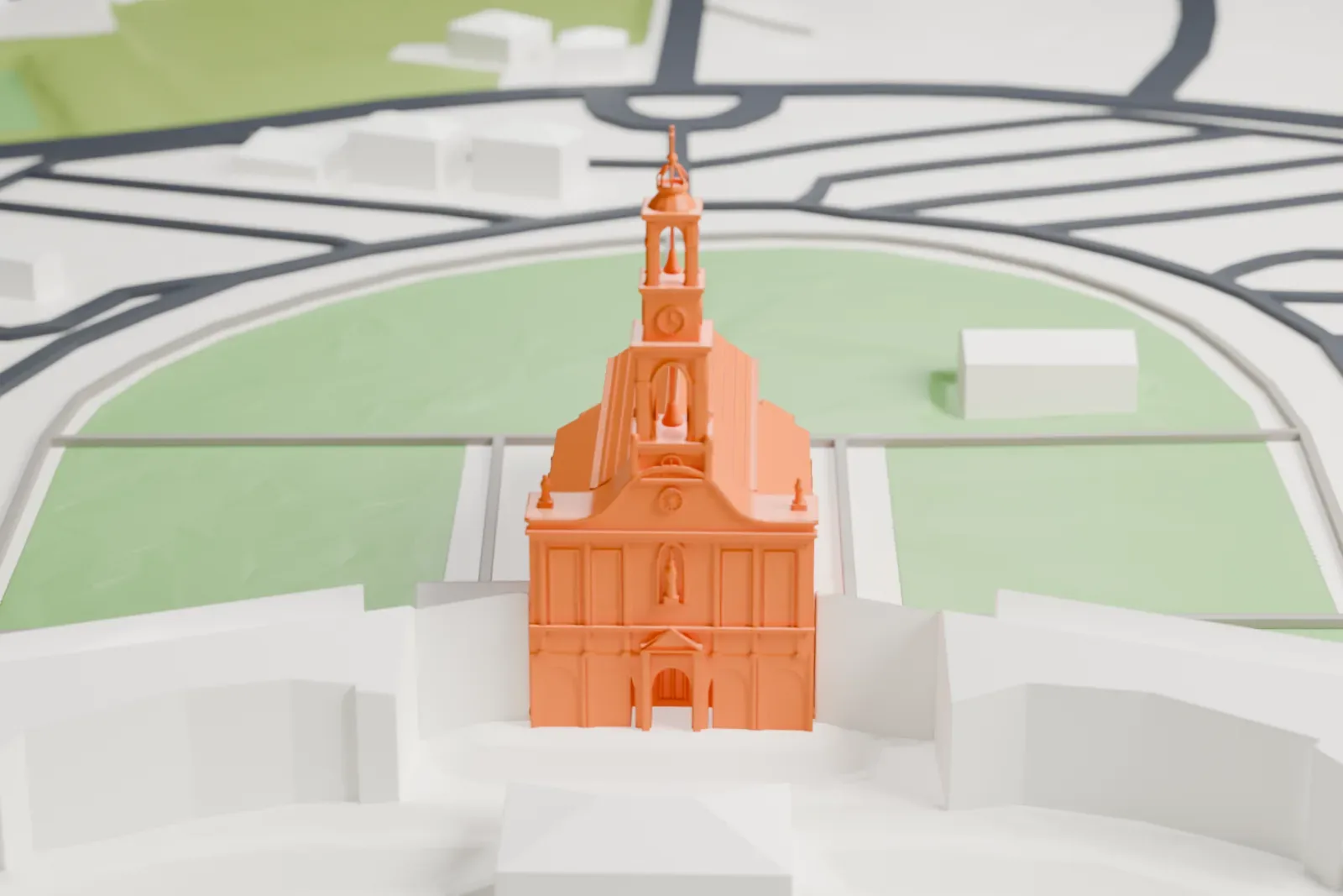 A white 3D print of the Sanctuary of Fátima's basilica, with a stepped bell tower, five entrance arches and a long pitched nave, standing among surrounding buildings.