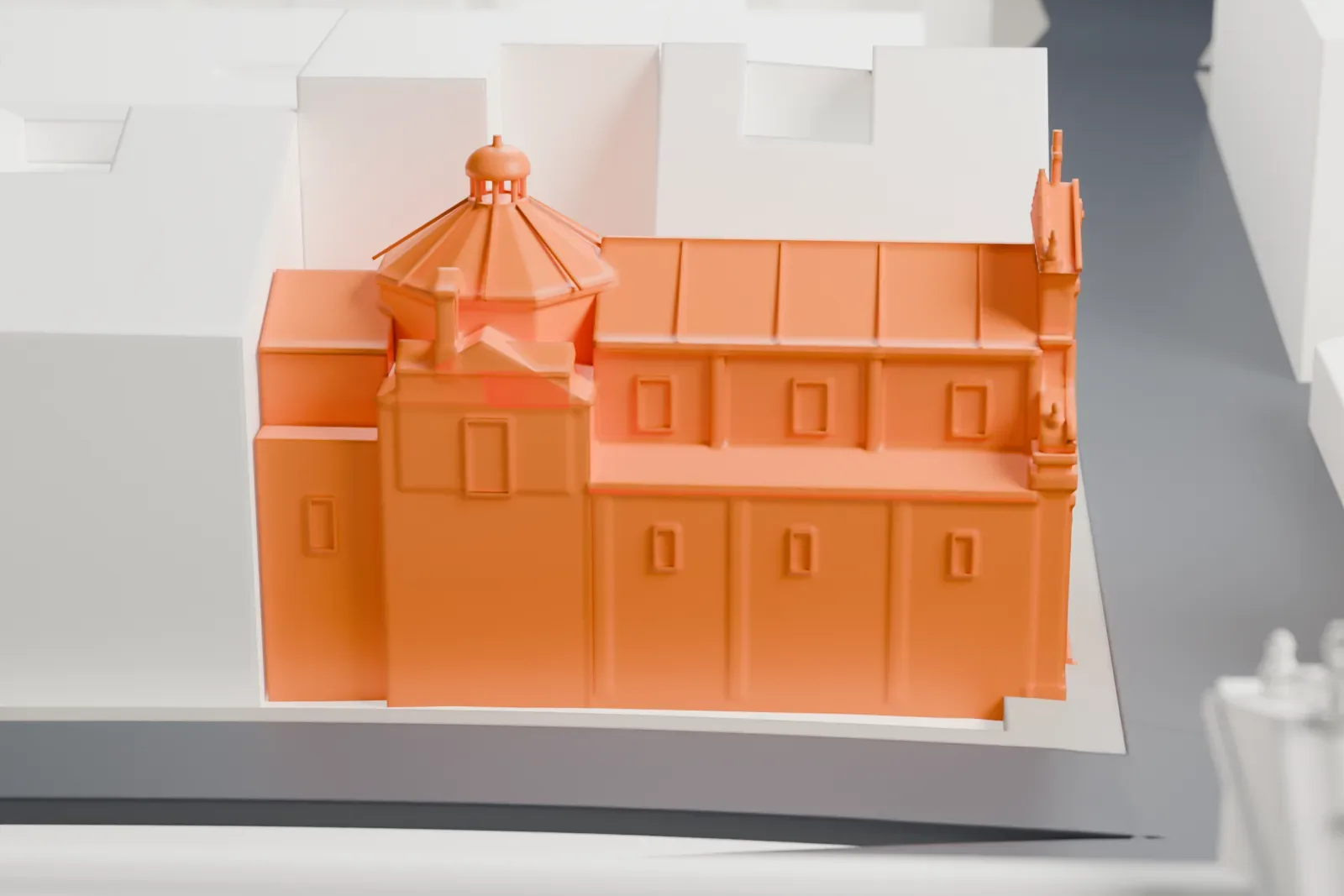 A white 3D print of the church of Santa Maria della Vittoria in Rome, with the surrounding buildings of the city around it.