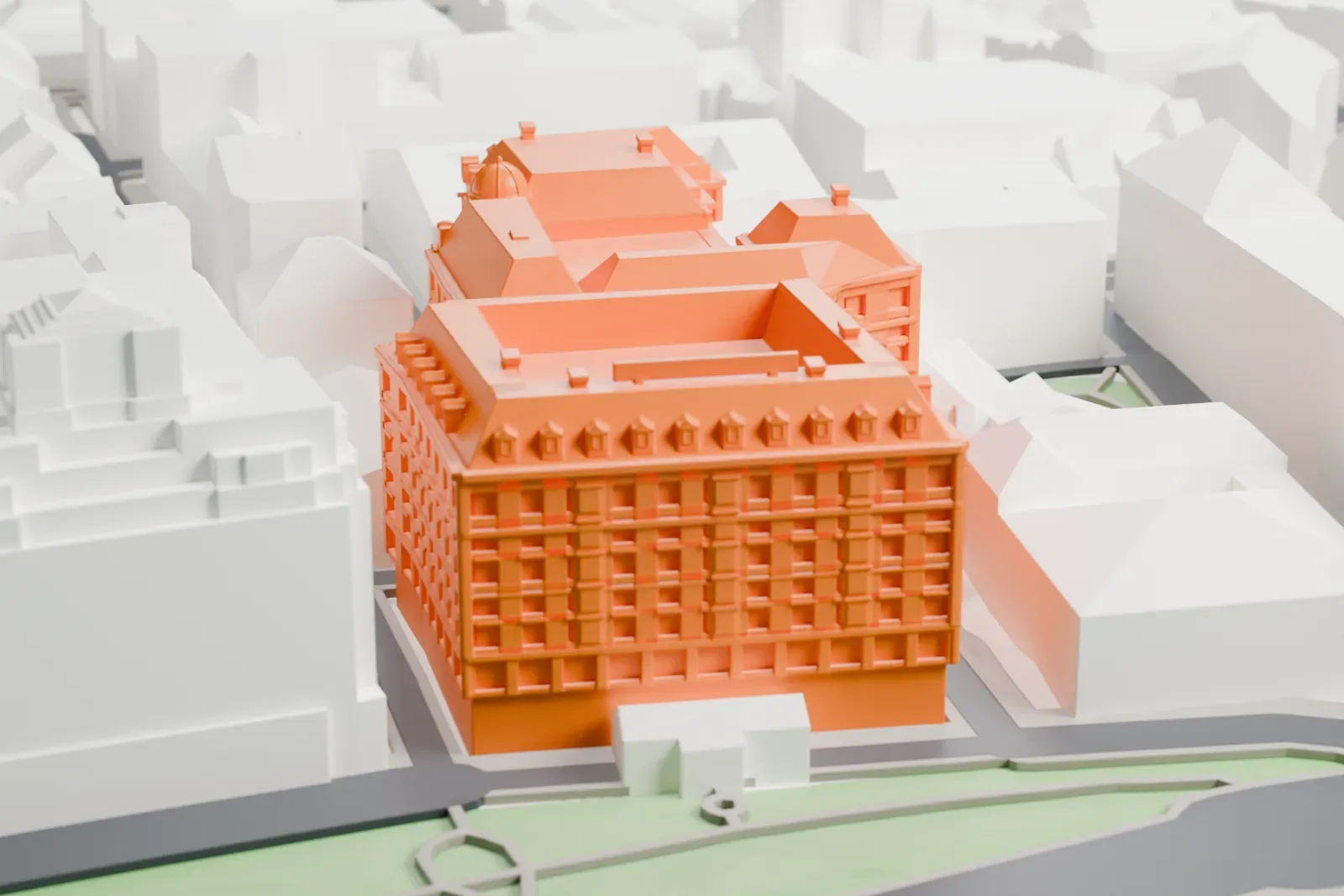 A white 3D print of the Savoy Hotel, a long, low hotel block with an even roofline, standing among the surrounding streets and buildings of central London.