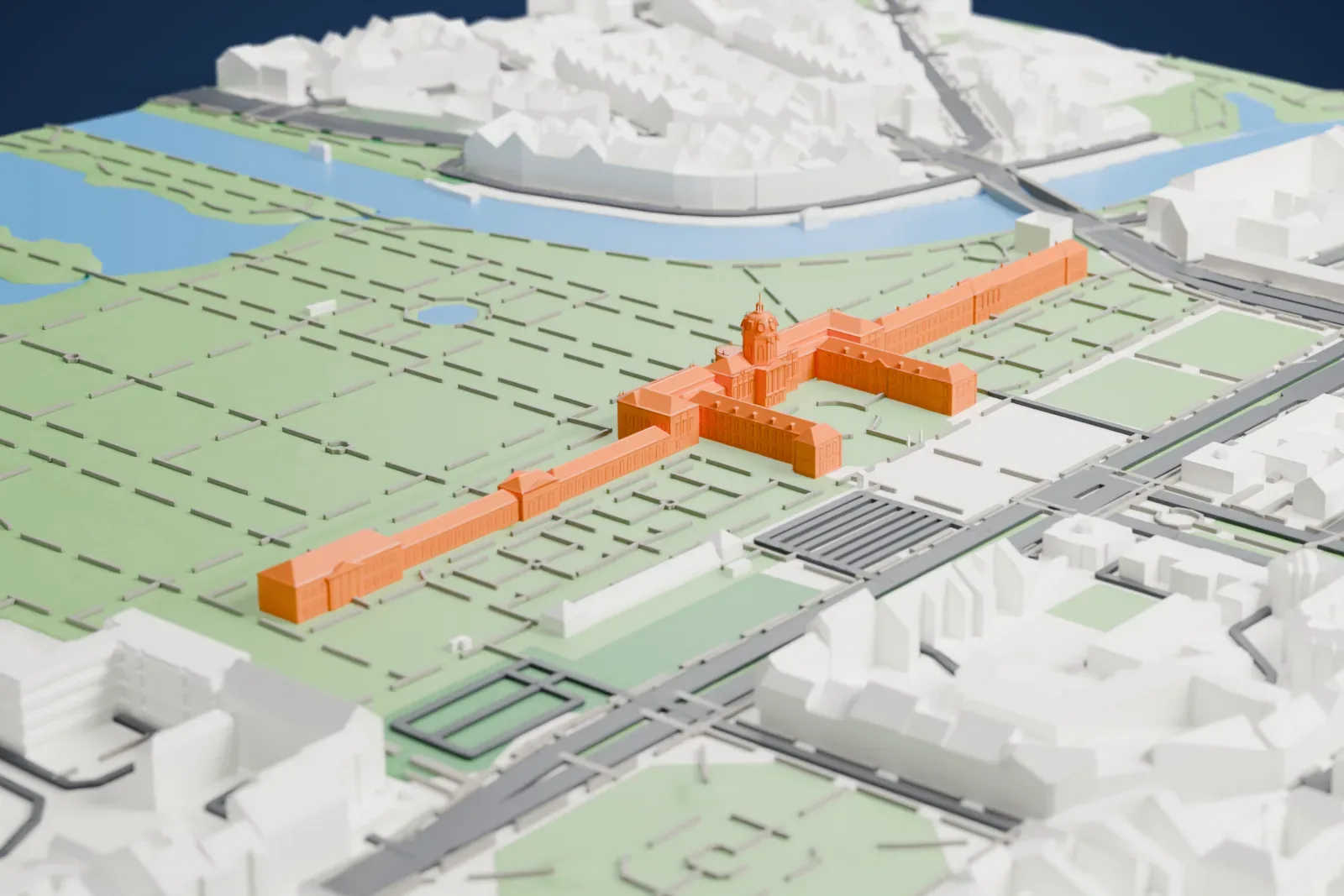 A white 3D print of Charlottenburg Palace, a long palace with a domed central tower and wings around a courtyard, set in a large garden of straight paths beside a river and a lake, with city blocks around.