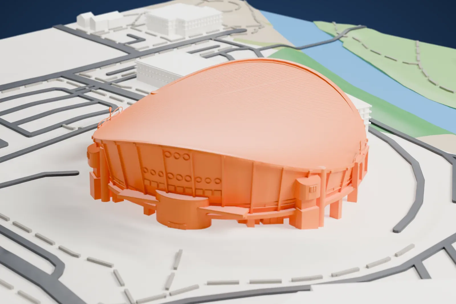 A white 3D print of the Scotiabank Saddledome, an arena with a saddle-shaped roof, set among roads and open ground with a band of water beyond.