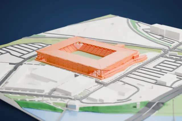 A white 3D print of ScottsMiracle-Gro Field, a square soccer stadium with a broad canopy roof on angled supports around a green pitch, beside roads, large low buildings and a bit of water.