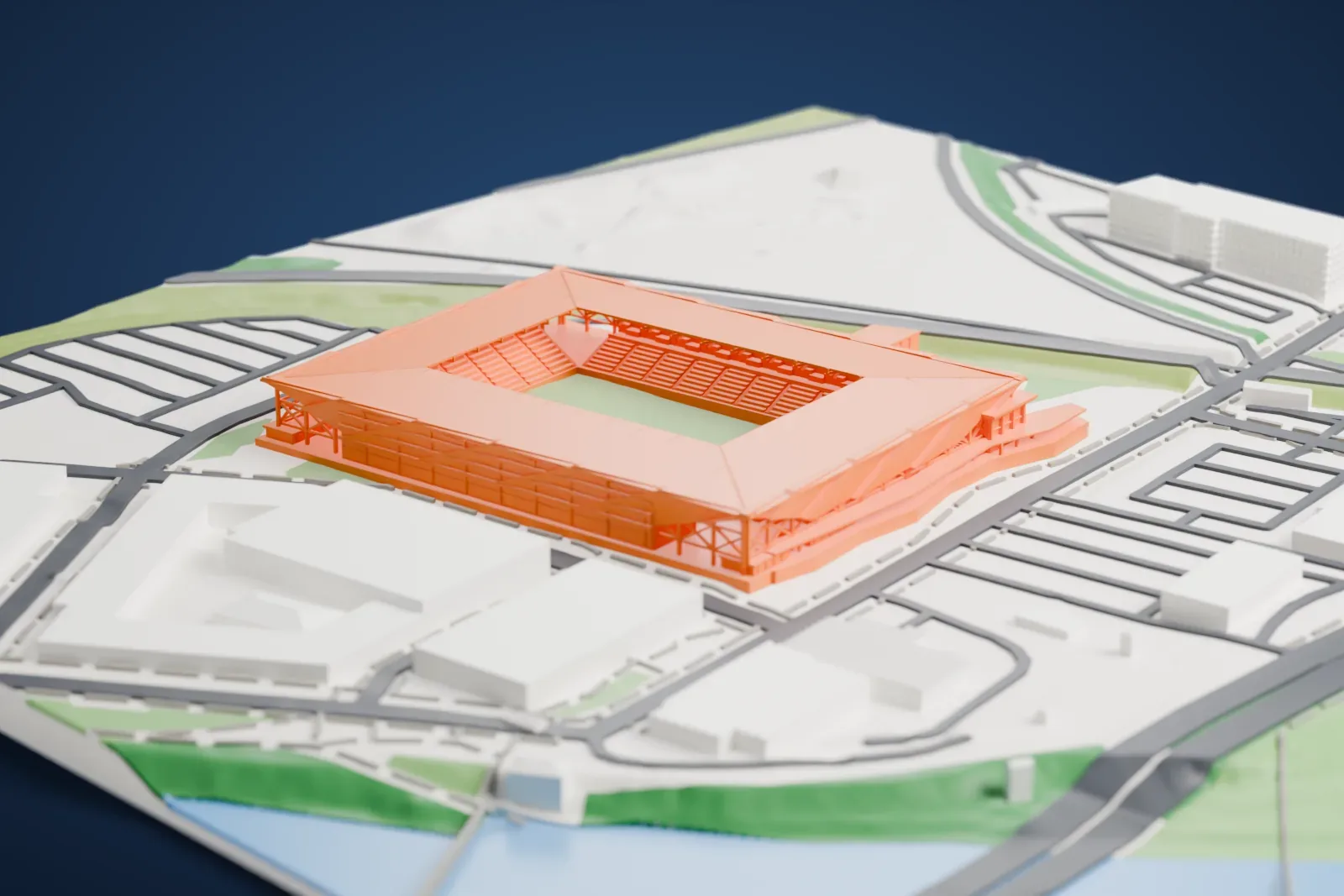 A white 3D print of ScottsMiracle-Gro Field, a square soccer stadium with a broad canopy roof on angled supports around a green pitch, beside roads, large low buildings and a bit of water.