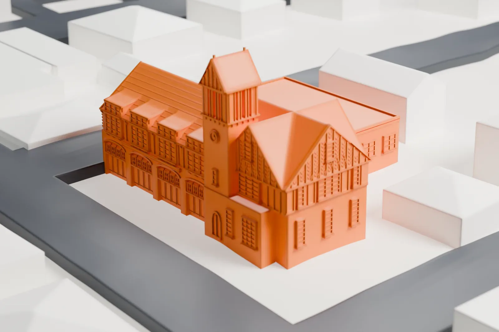 A white 3D print of the Sea Cliff Firehouse, a brick fire station with a steep roof and a bell tower, among smaller houses on neighboring streets.