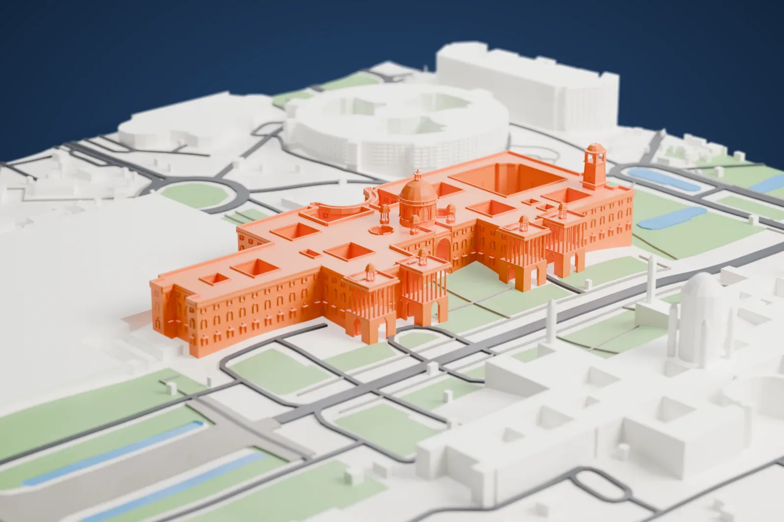 A white 3D print of the Secretariat Building, with its domed drum, colonnaded wings and tall bell tower, on Raisina Hill among surrounding buildings.
