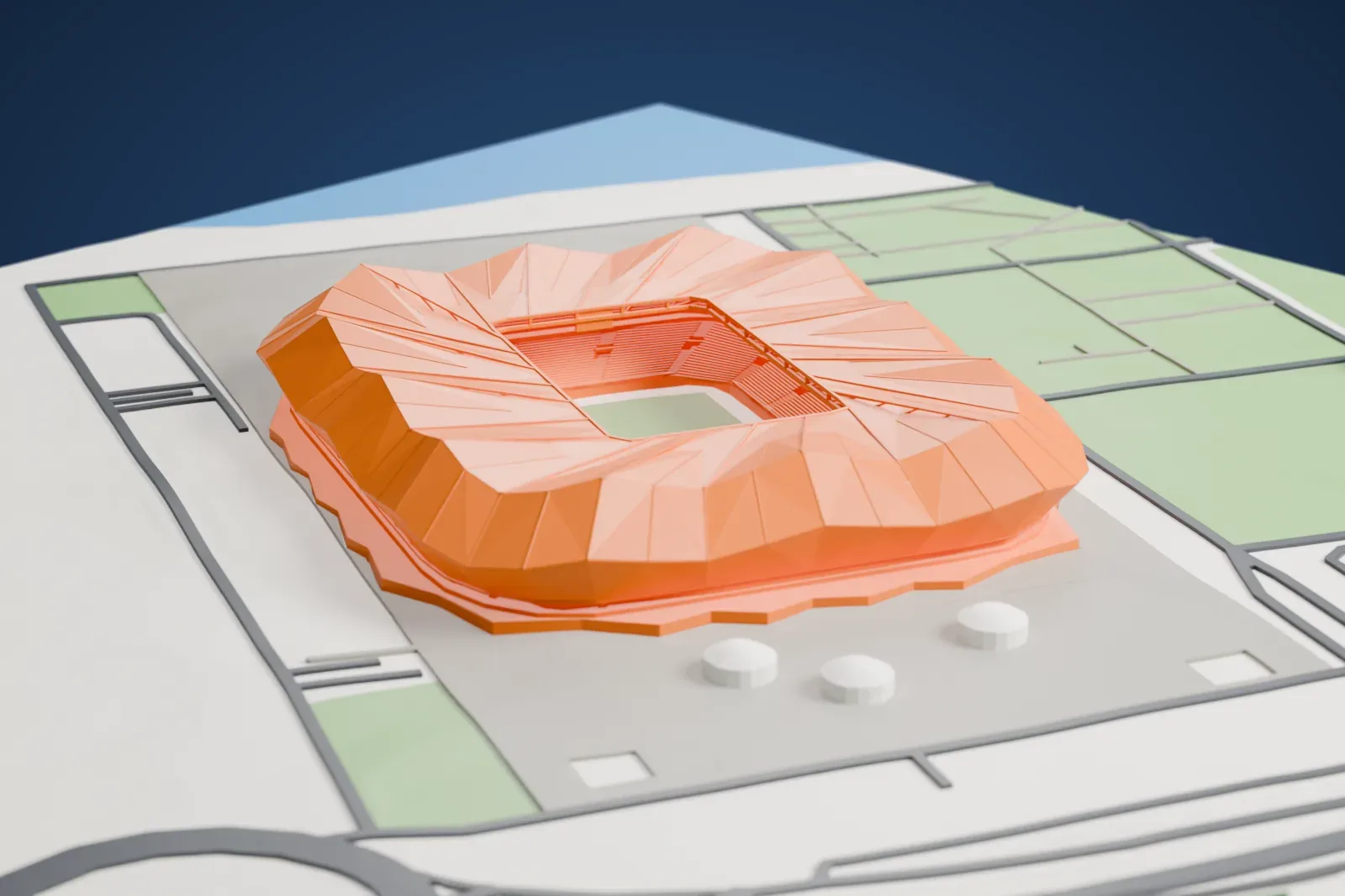 A white 3D print of Şenol Güneş Sports Complex, a compact stadium with a folded roof and open center, set among surrounding streets and buildings.