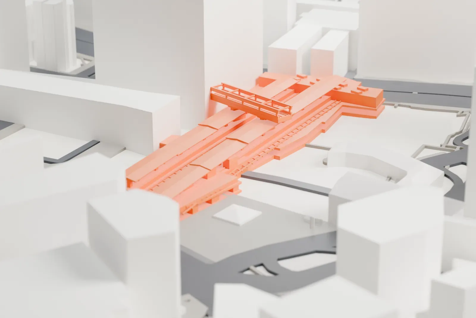 A white 3D print of Shibuya Station, a wide low station complex with a long roofline, among dense city blocks and streets.