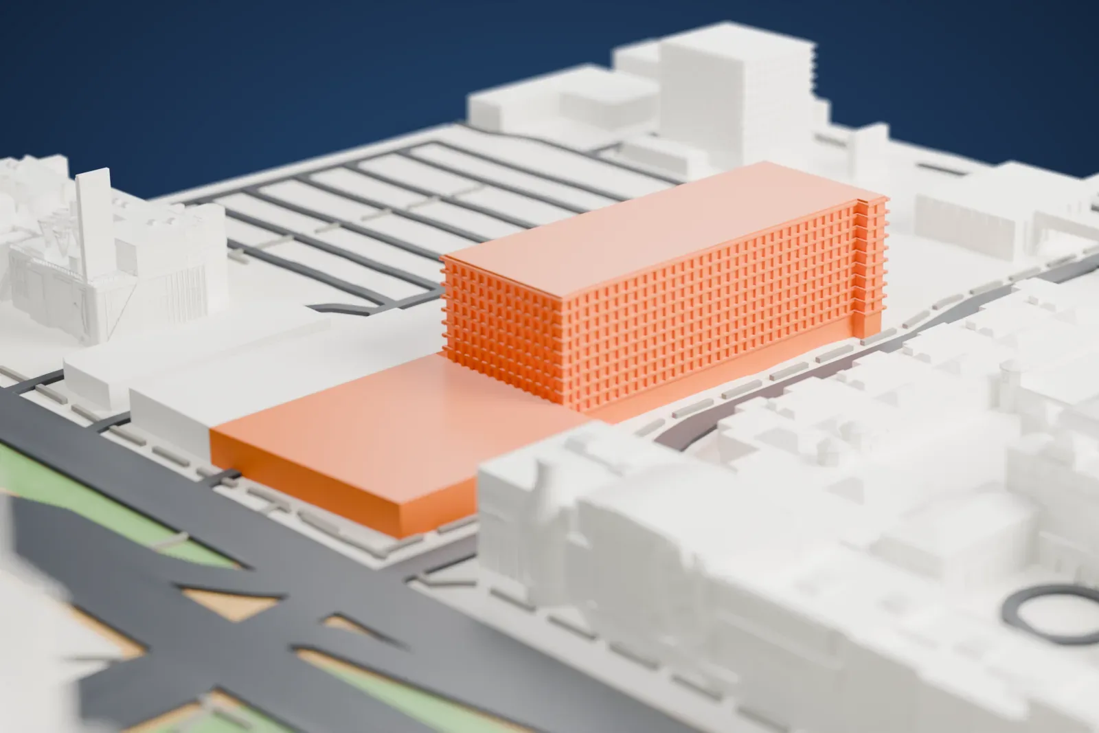 A white 3D print of Showcase Mall, a long, stepped shopping center with a bottle-shaped tower and signs on its facade, set among tall towers and wide roads.