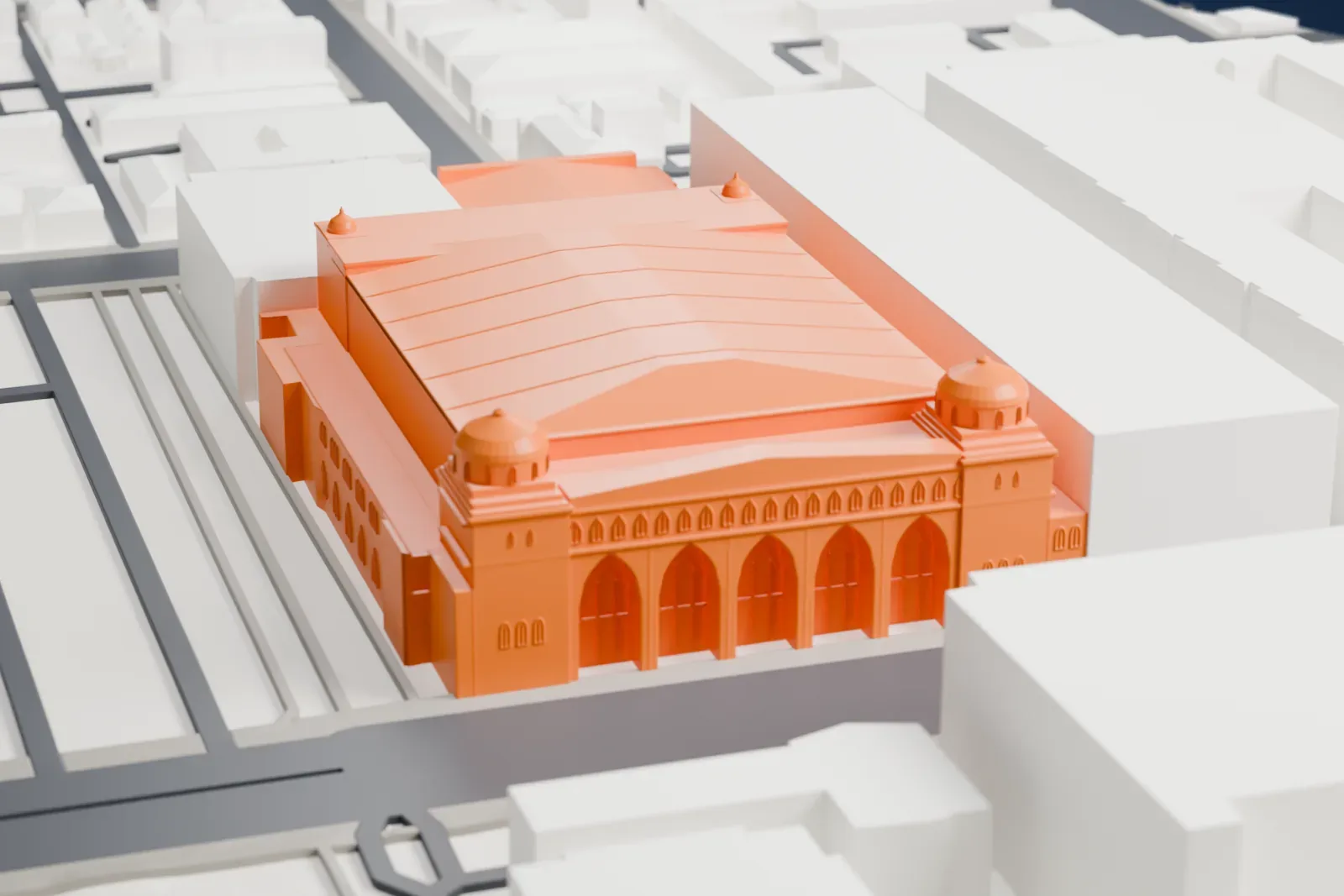 A white 3D print of the Shrine Auditorium and Expo Hall, a broad building mass on its footprint, with streets and buildings around it.