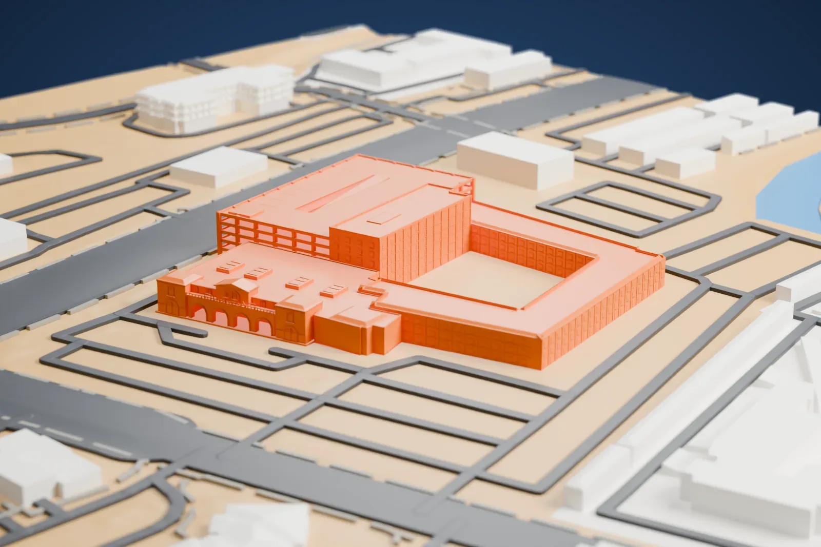 A white 3D print of Silver Sevens, a U-shaped hotel block around an open center with a multi-level garage and a low entrance wing, among streets and open ground.