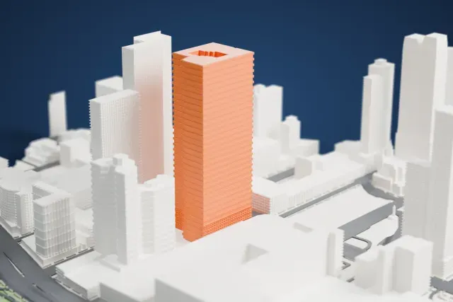 A white 3D print of the Silver Towers II model in New York, with the streets around it.