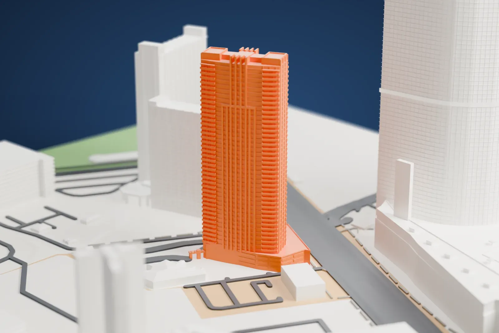 A white 3D print of Sky Las Vegas, a tall slim tower with balcony ledges on every floor and a stepped top above a low podium, among larger neighboring towers.
