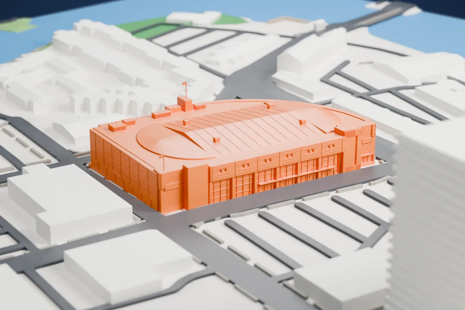 A white 3D print of Slush Puppie Place, a curved oval-roofed arena, in a downtown grid of streets with buildings on all sides and a little parkland.