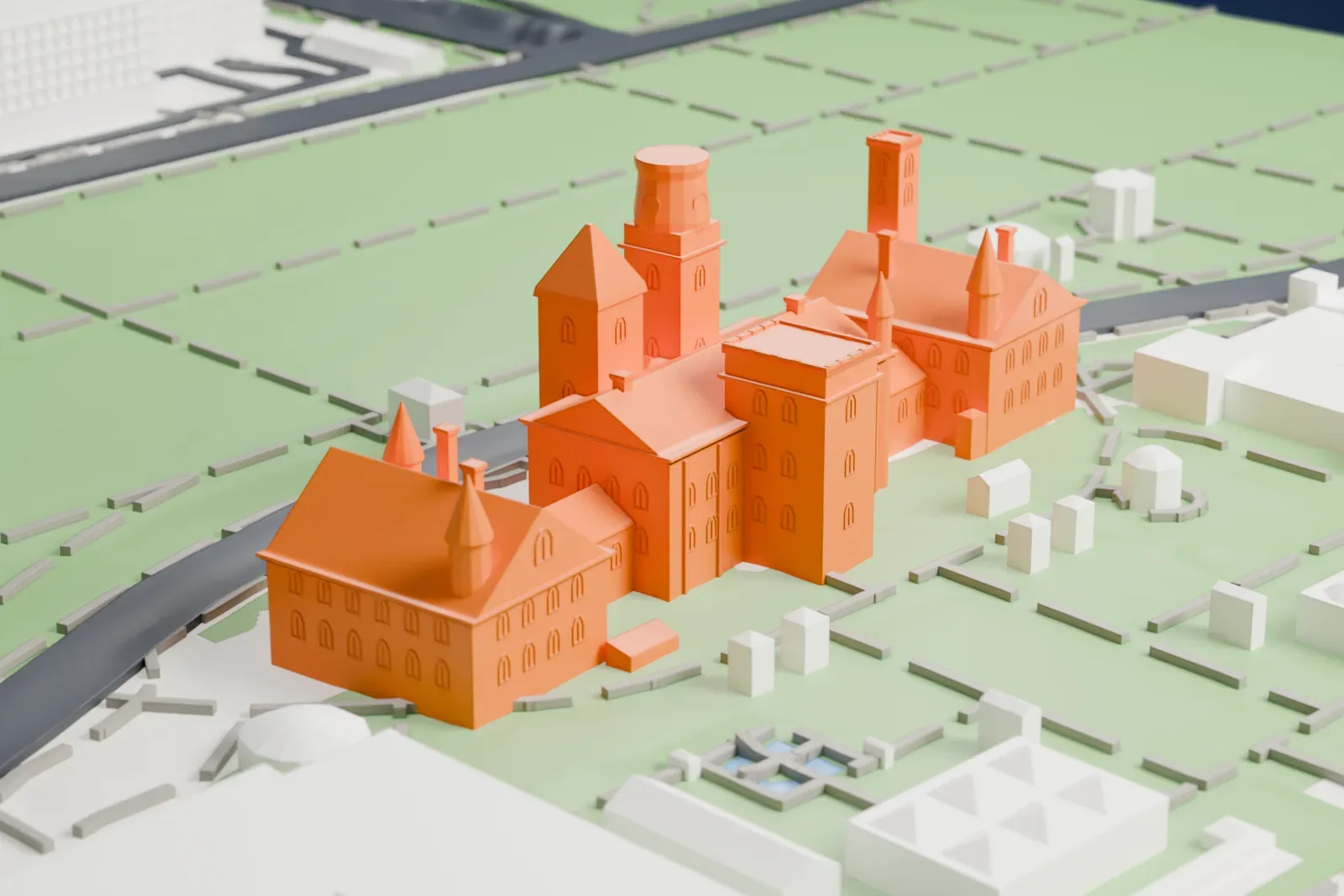 A white 3D print of the Smithsonian Castle, with its towers, spires and wings, standing in a green park beside a curving road.