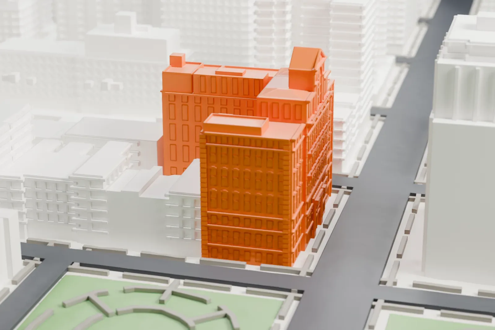 A white 3D print of the Society for the Lying-In Hospital, a tall ornate block with a gabled crown, beside a park and among taller buildings.