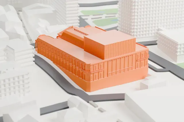 A white 3D print of Solís Theatre, a large columned building with a ribbed roof over its hall, set among taller buildings and narrow streets.