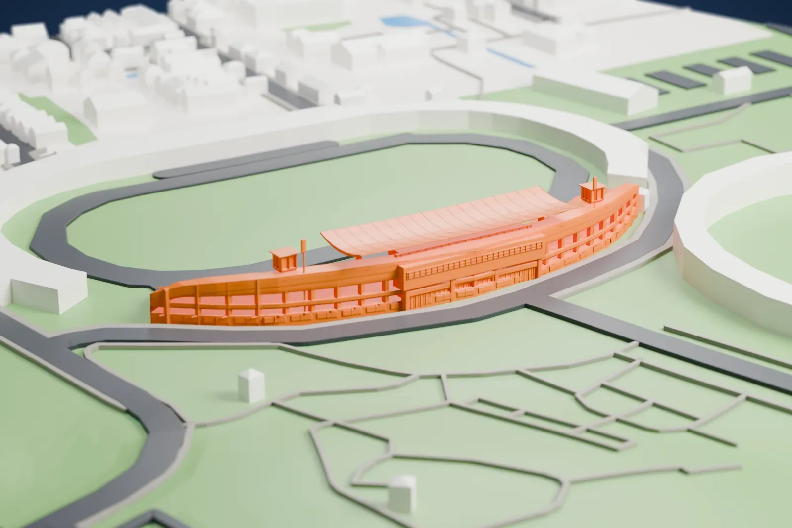 A white 3D print of Soyu Stadium's curved main stand beside the open field, with the surrounding grounds, streets and houses.