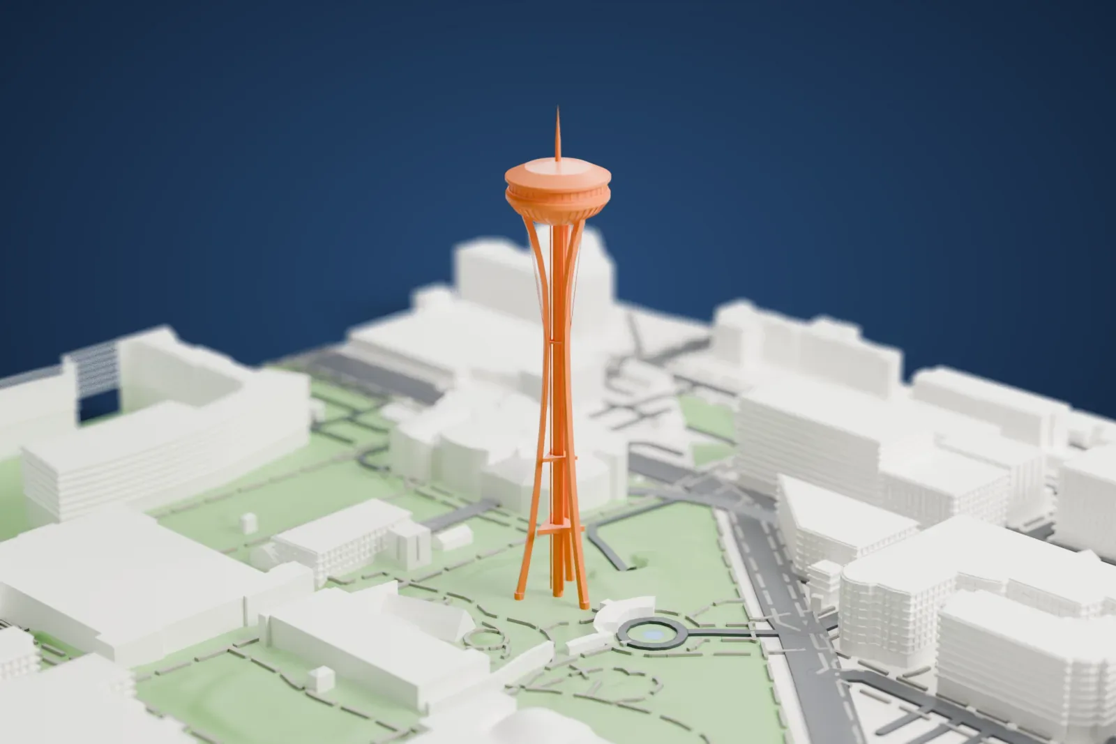 A white 3D print of the Space Needle, with its saucer-shaped top and slender hourglass legs, standing on green lawns among the low buildings and roads of Seattle Center.