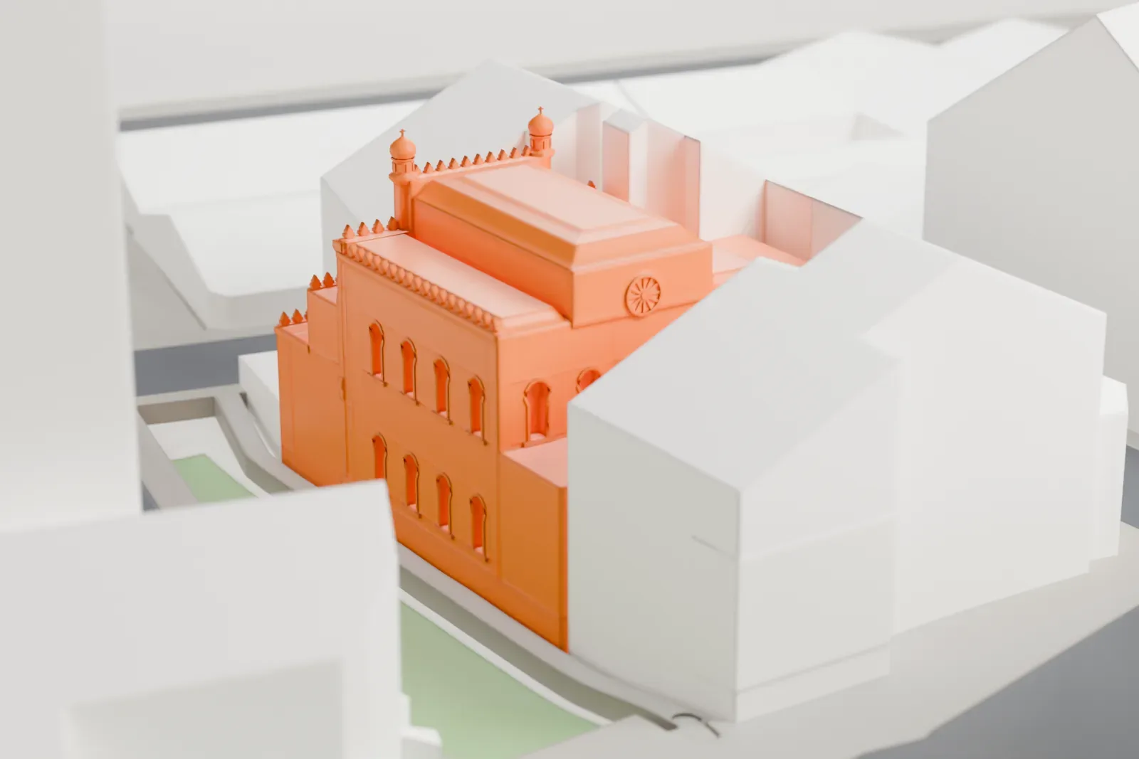 A white 3D print of the Spanish Synagogue, a domed Moorish Revival building, standing among the surrounding buildings of Prague's Jewish Town.
