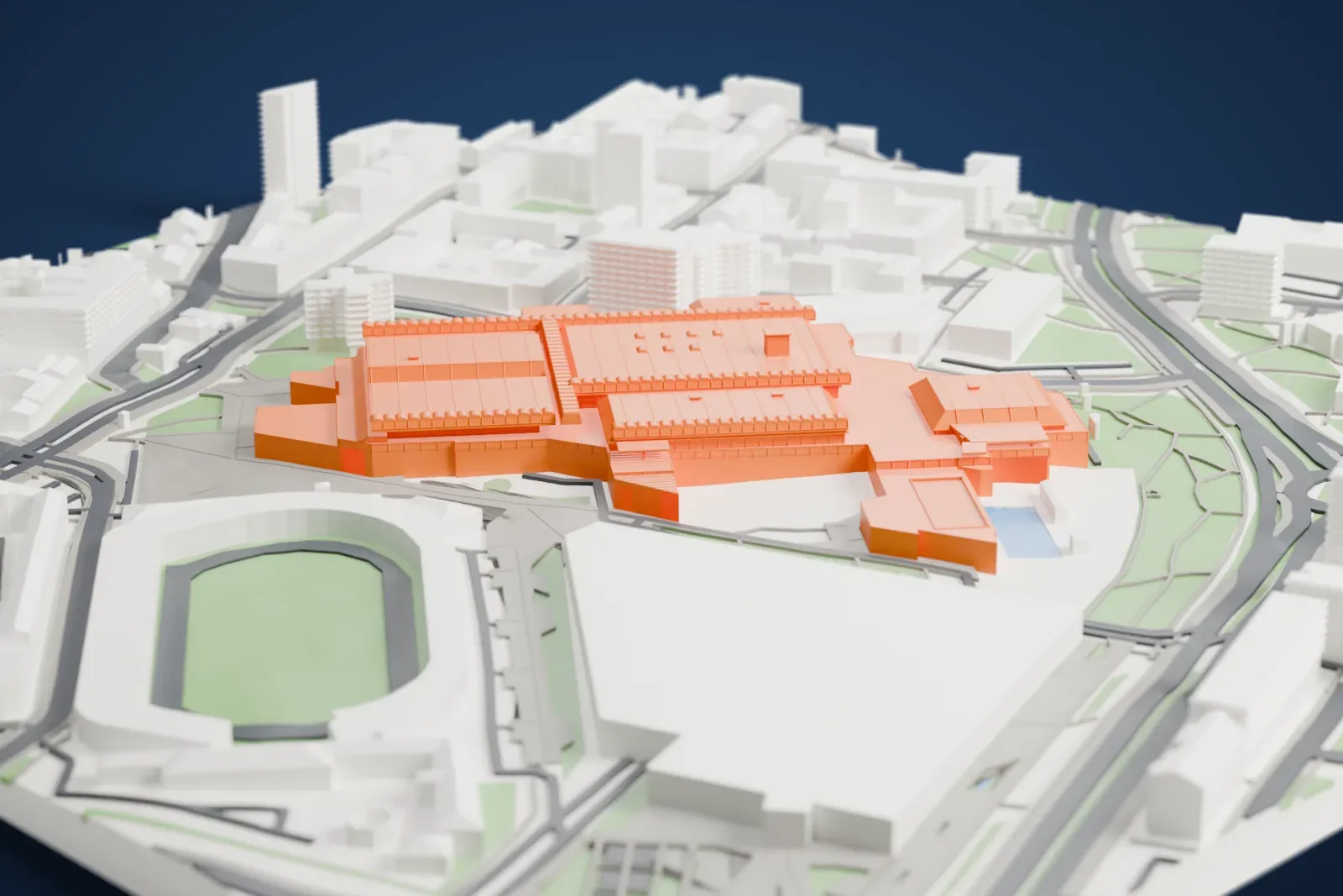 A white 3D print of SPC Vojvodina, a large complex of connected halls with ridged roofs, among surrounding streets, buildings and green areas.