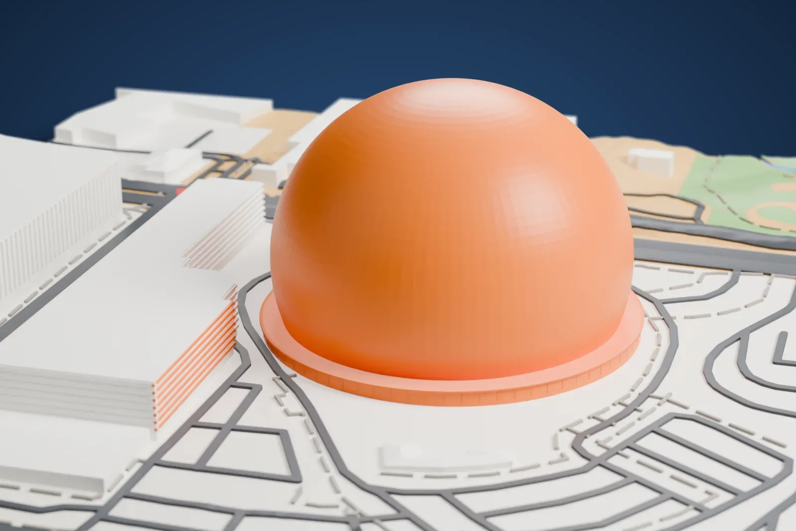 A white 3D print of Sphere, a smooth hemispherical dome on a round platform ring, set among curving roads, parking areas and nearby buildings.