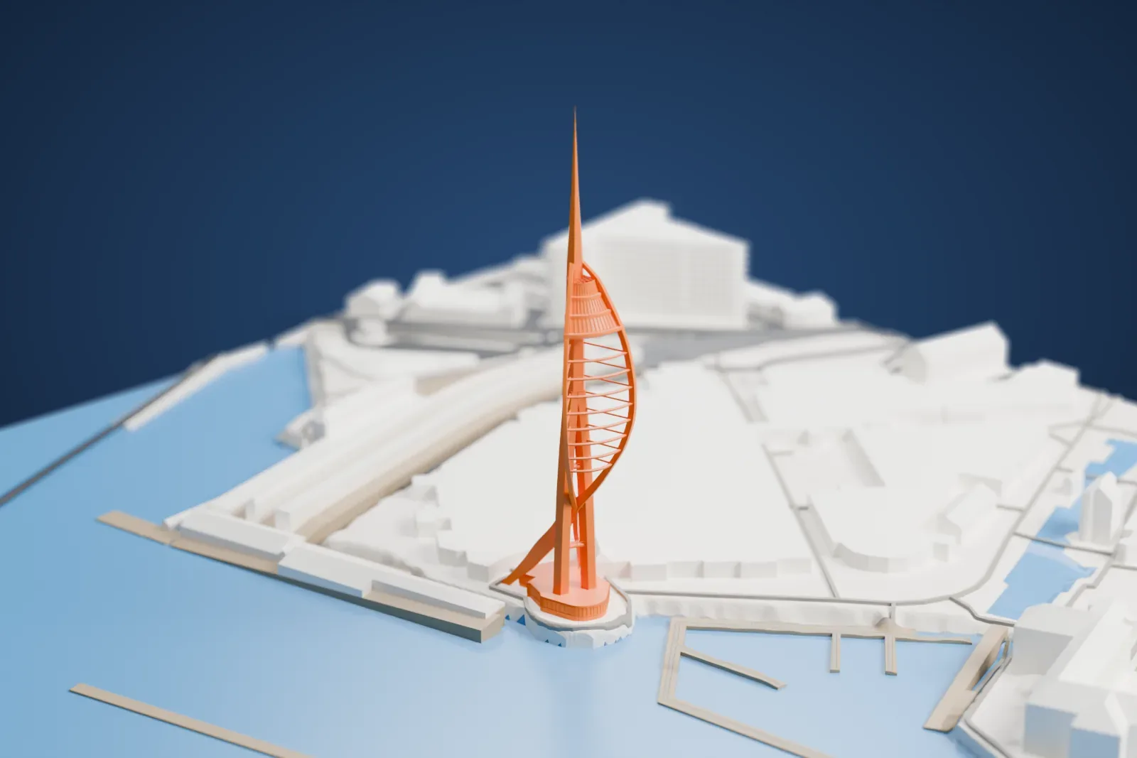 A white 3D print of the Spinnaker Tower, with its open sail, three observation decks and slender spire, among the surrounding streets and buildings.