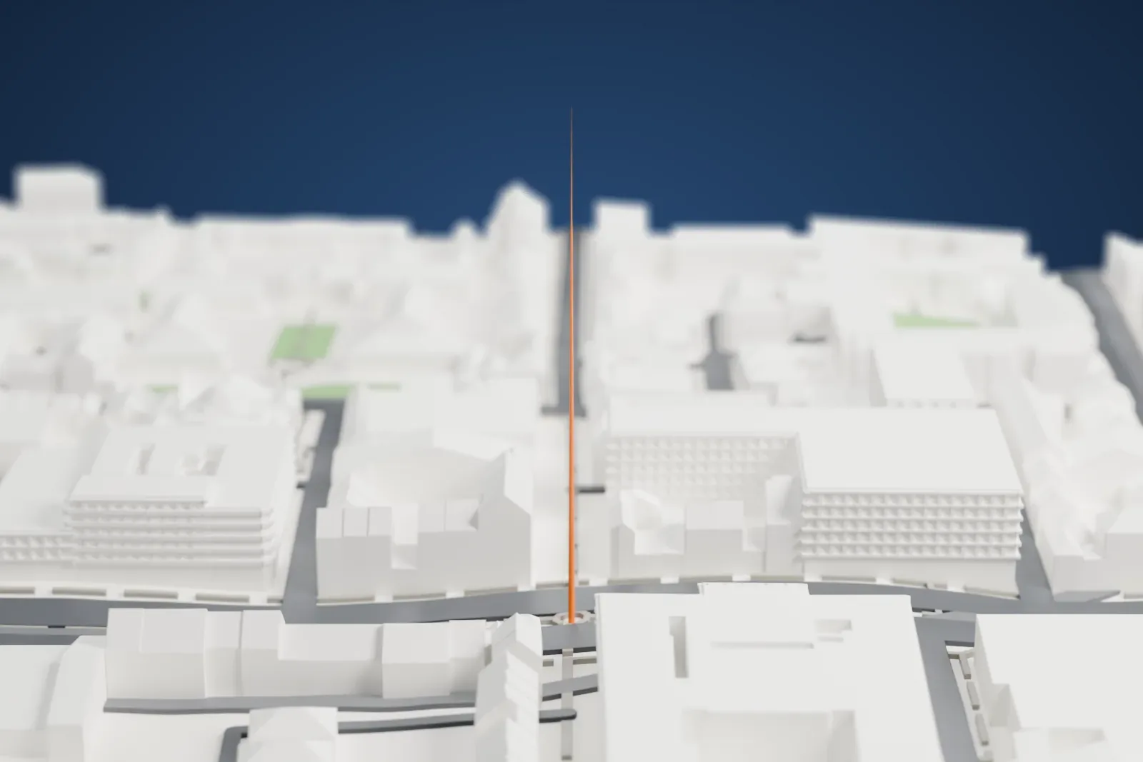 A white 3D print of the Spire of Dublin, a single needle-thin spire rising far above a wide street lined with mid-rise buildings.